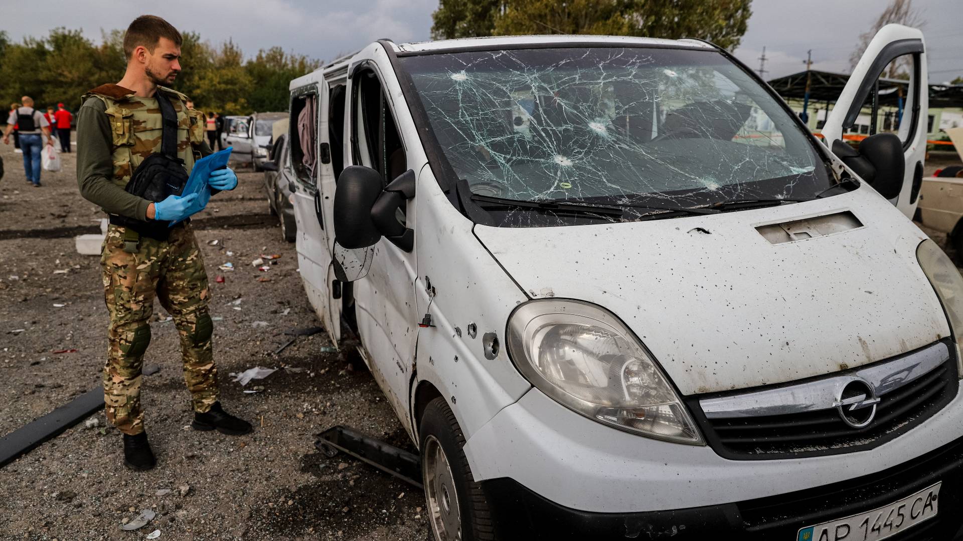 A Ukrainian serviceman checks the damage following the missile strike on a road near Zaporizhzhia. /Kateryna Klochko/AFP