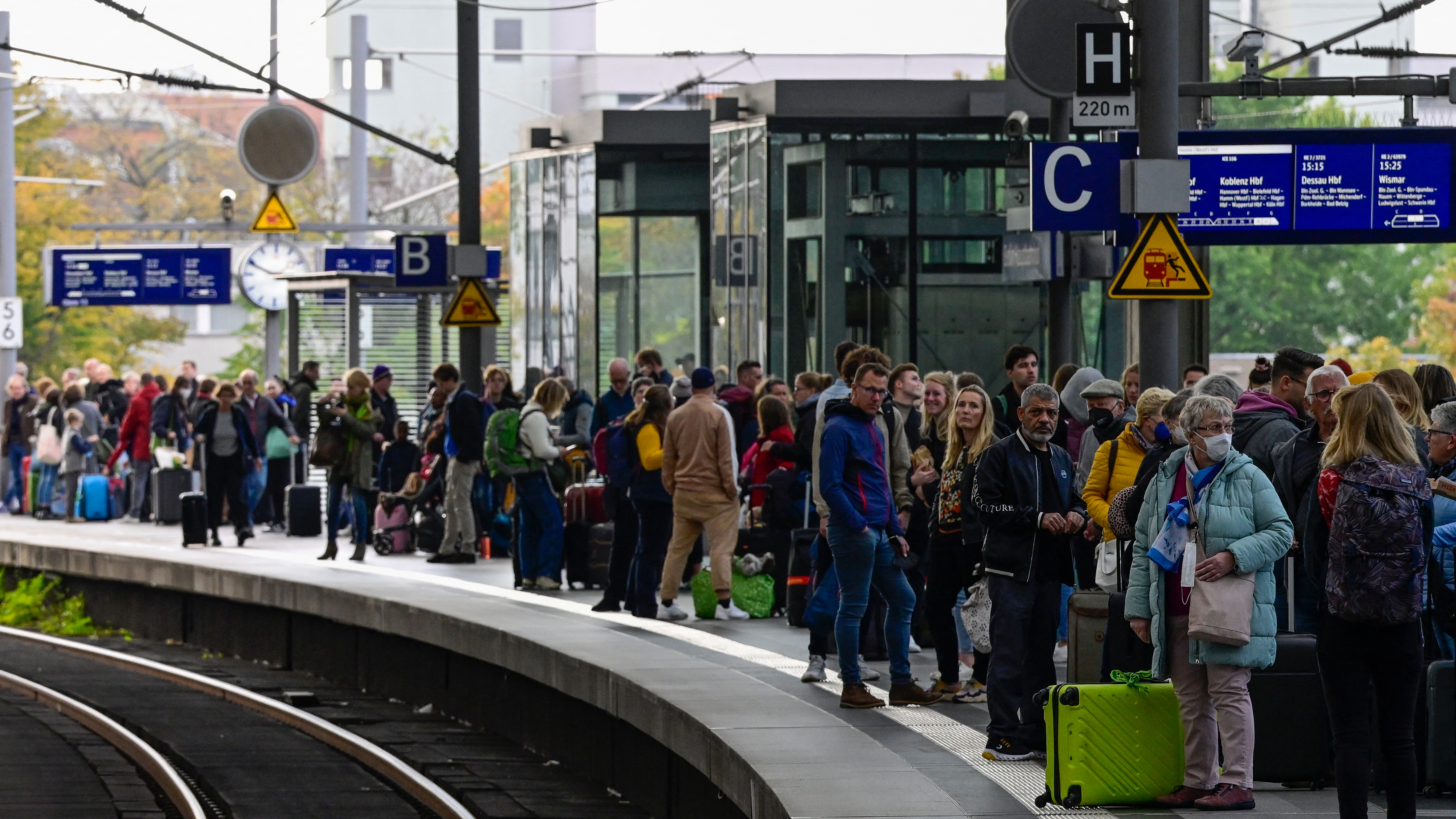 Rail passengers wait for a train on a platform at the main train station in Berlin.
John MacDougall / AFP