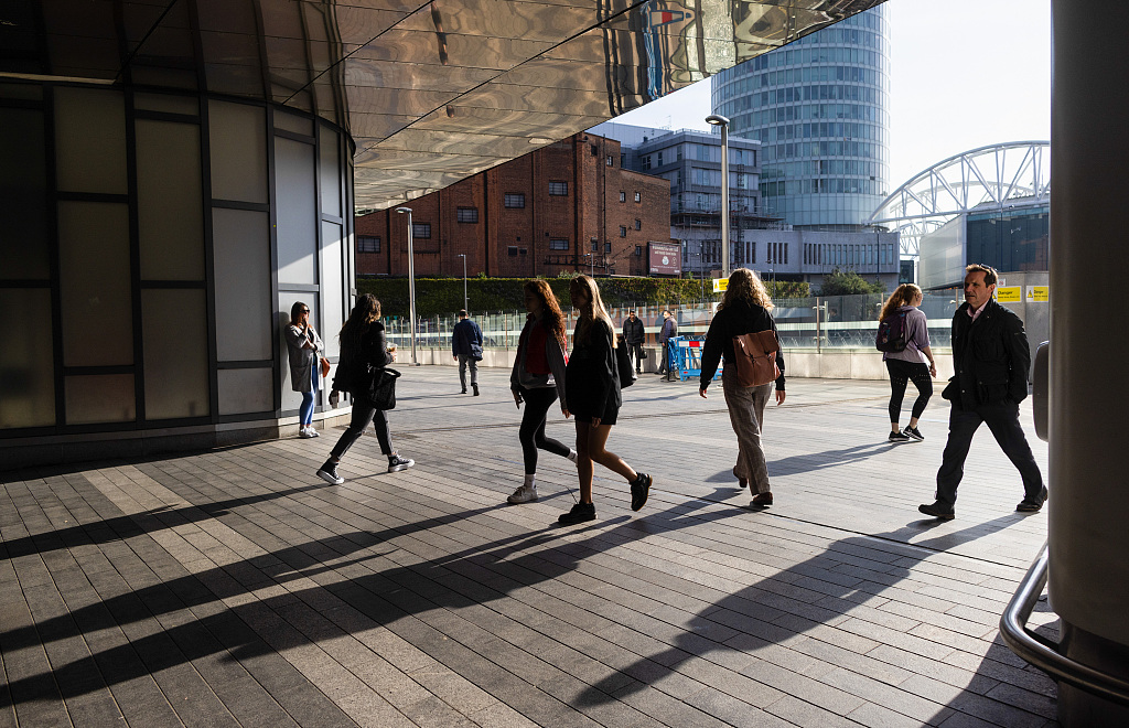 Commuters enter New Street railway station in Birmingham. /CFP