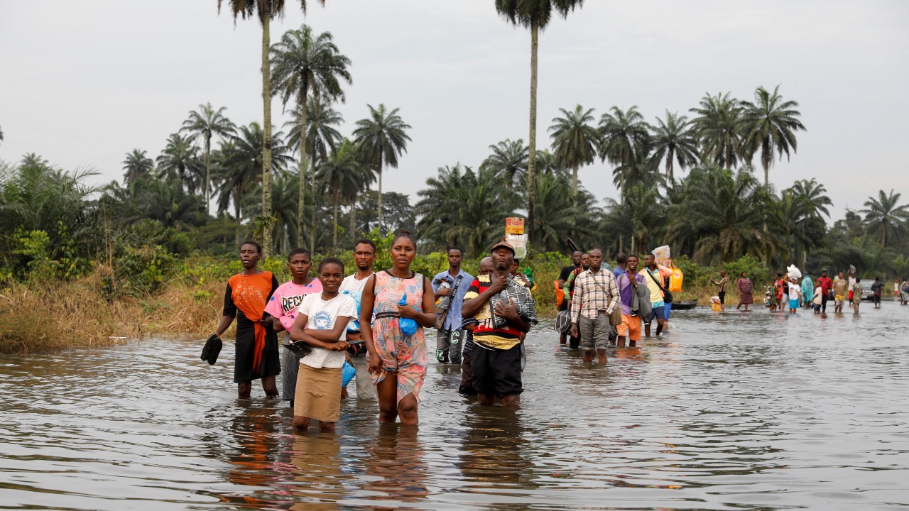 Residents wade through flood water in Obagi community, Rivers state, Nigeria. /Temilade Adelaja/Reuters