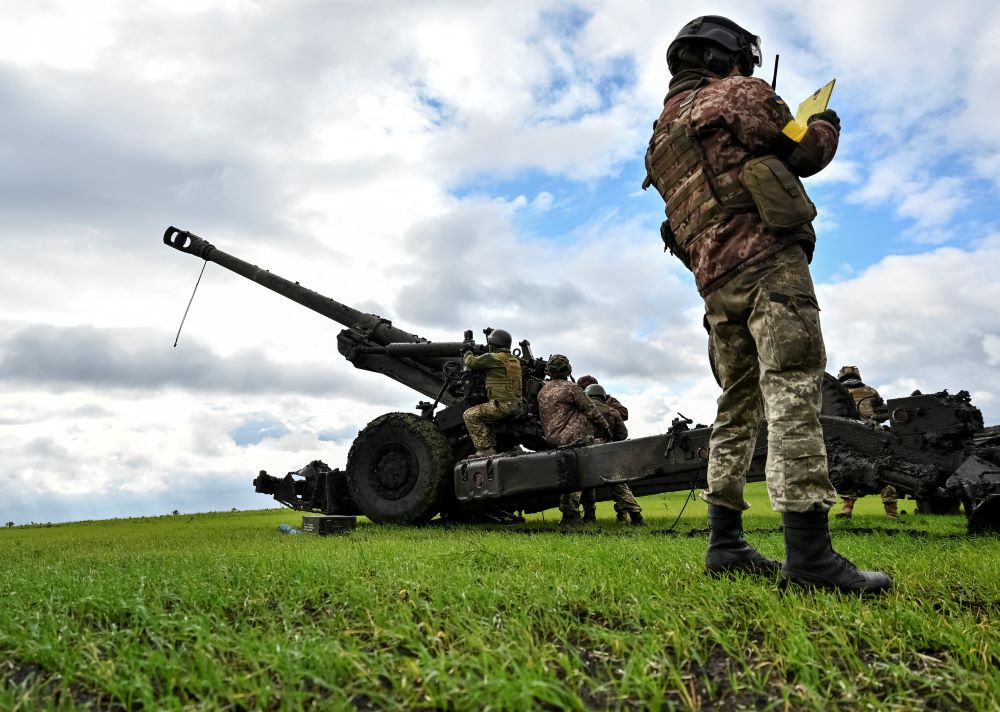 A Ukrainian soldier checks coordinates before firing a mobile artillery piece. /Stringer/Reuters