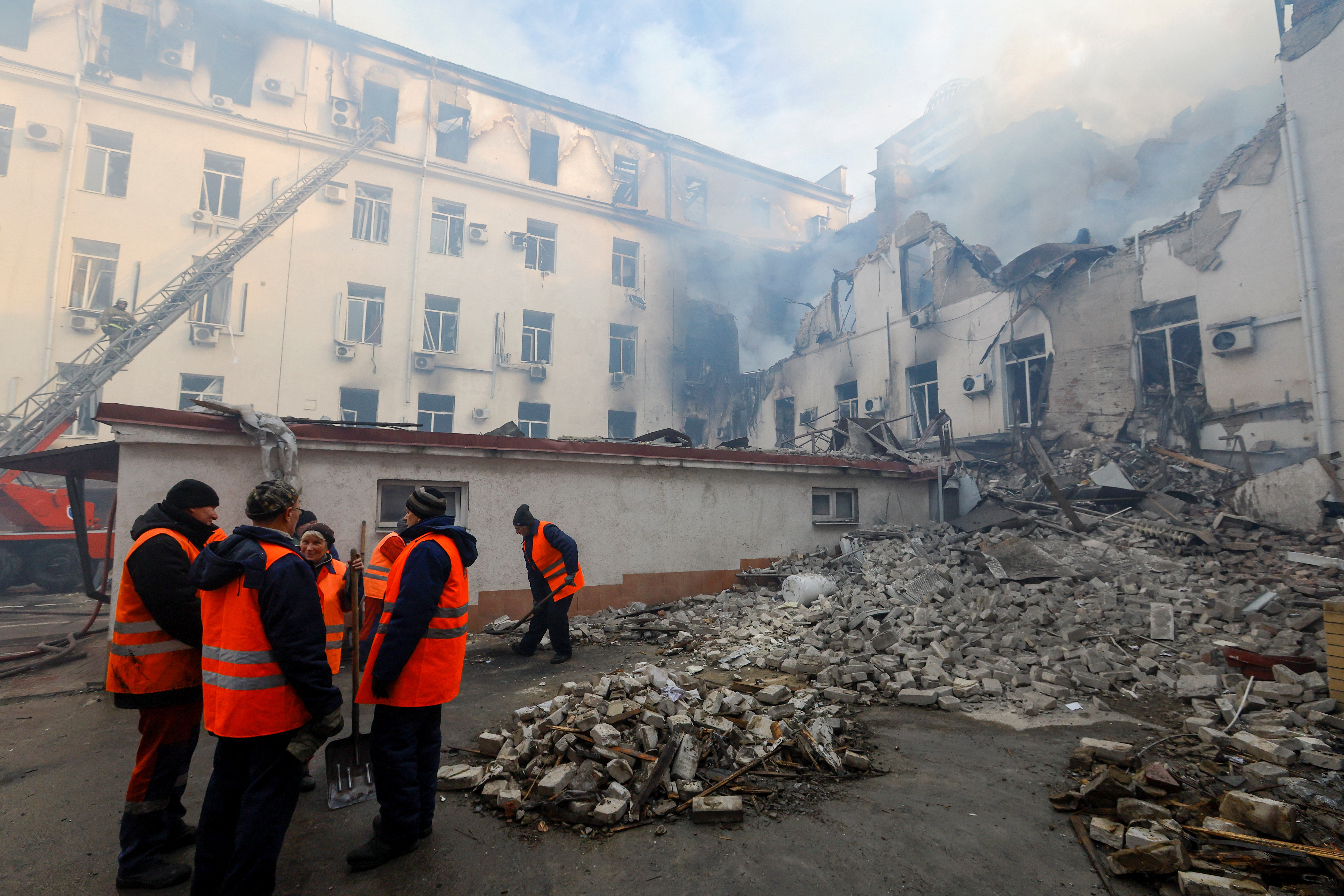 Workers remove debris from a building damaged by debris in Donetsk. Alexander Ermochenko/Reuters