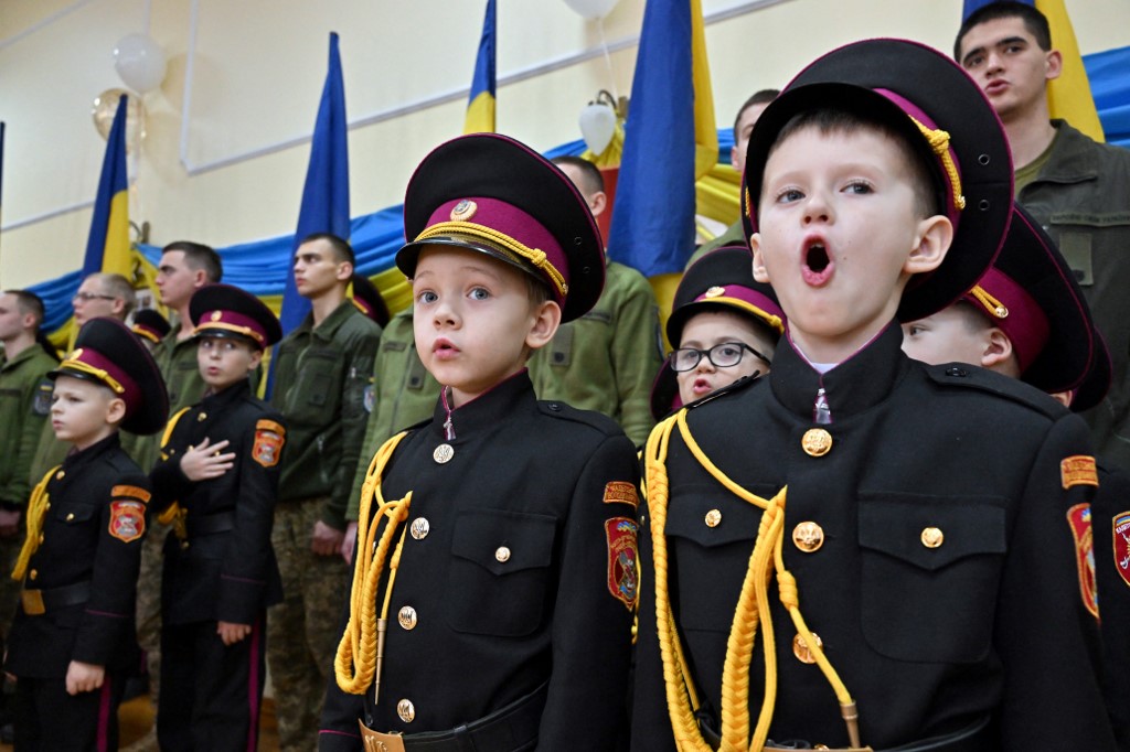Young cadets sing the national anthem during a ceremony for the 