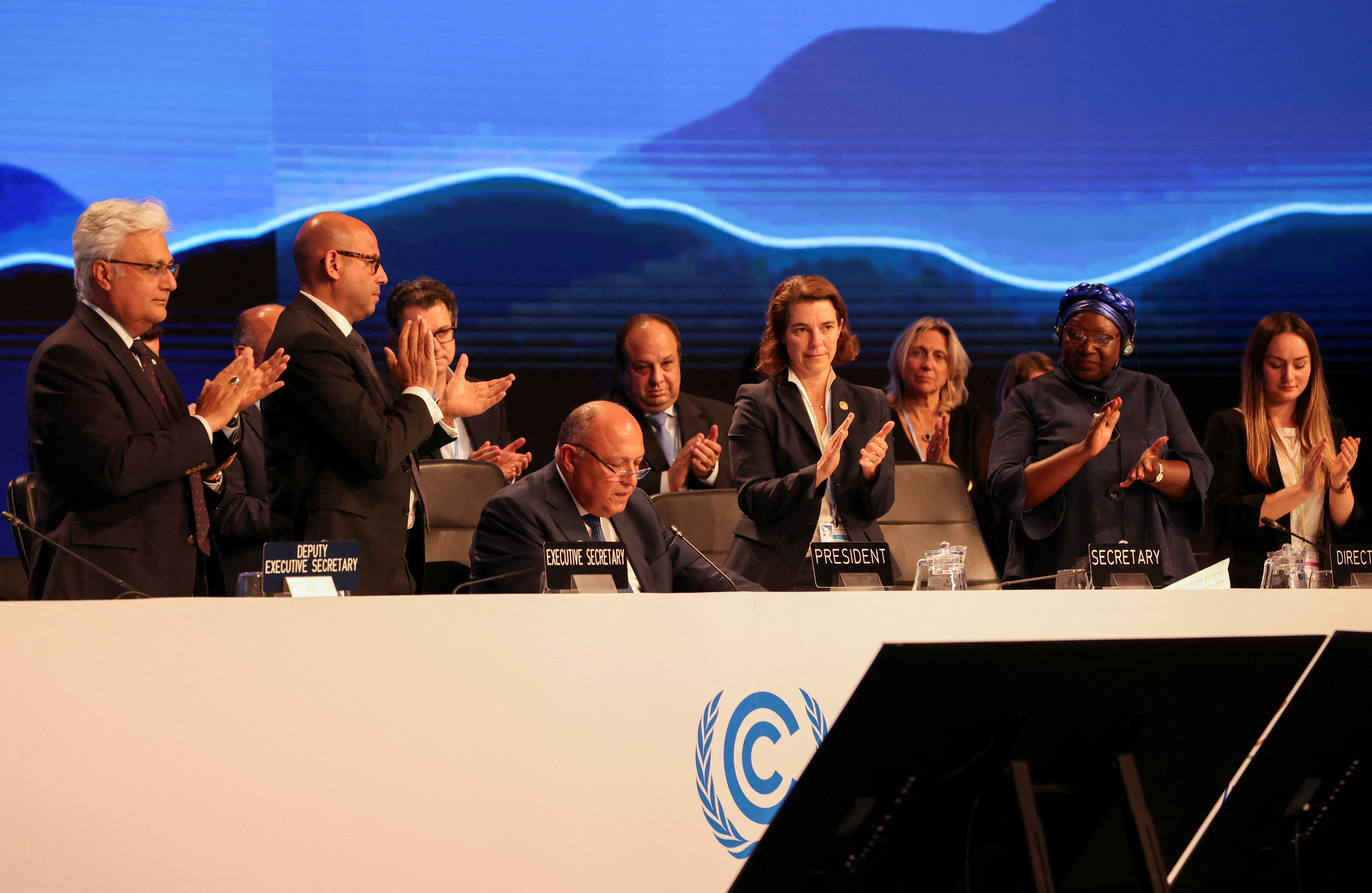 Delegates applaud as COP27 President Sameh Shoukry delivers a statement during the closing plenary at the COP27 climate summit in Sharm el-Sheikh. REduters /Mohamed Abd El Ghany