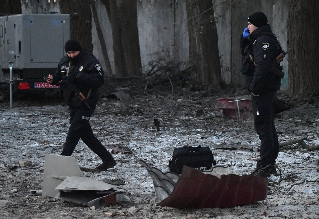 Police experts examine the remains of a drone following a strike on an administrative building in Kyiv. Sergei Supinsky/AFP