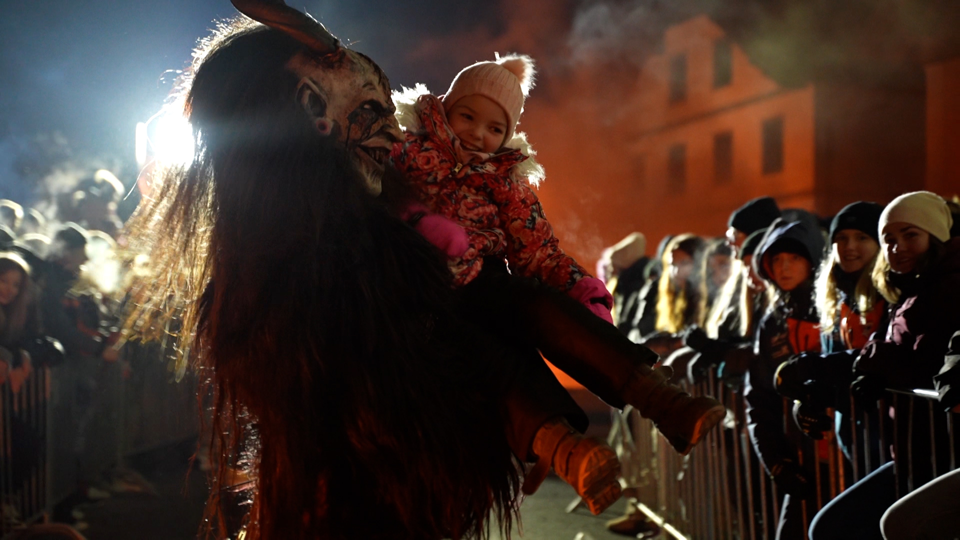 Some Krampus impersonators are trying to take the fear from small children by carrying them around. /CGTN/Andreas Gasser