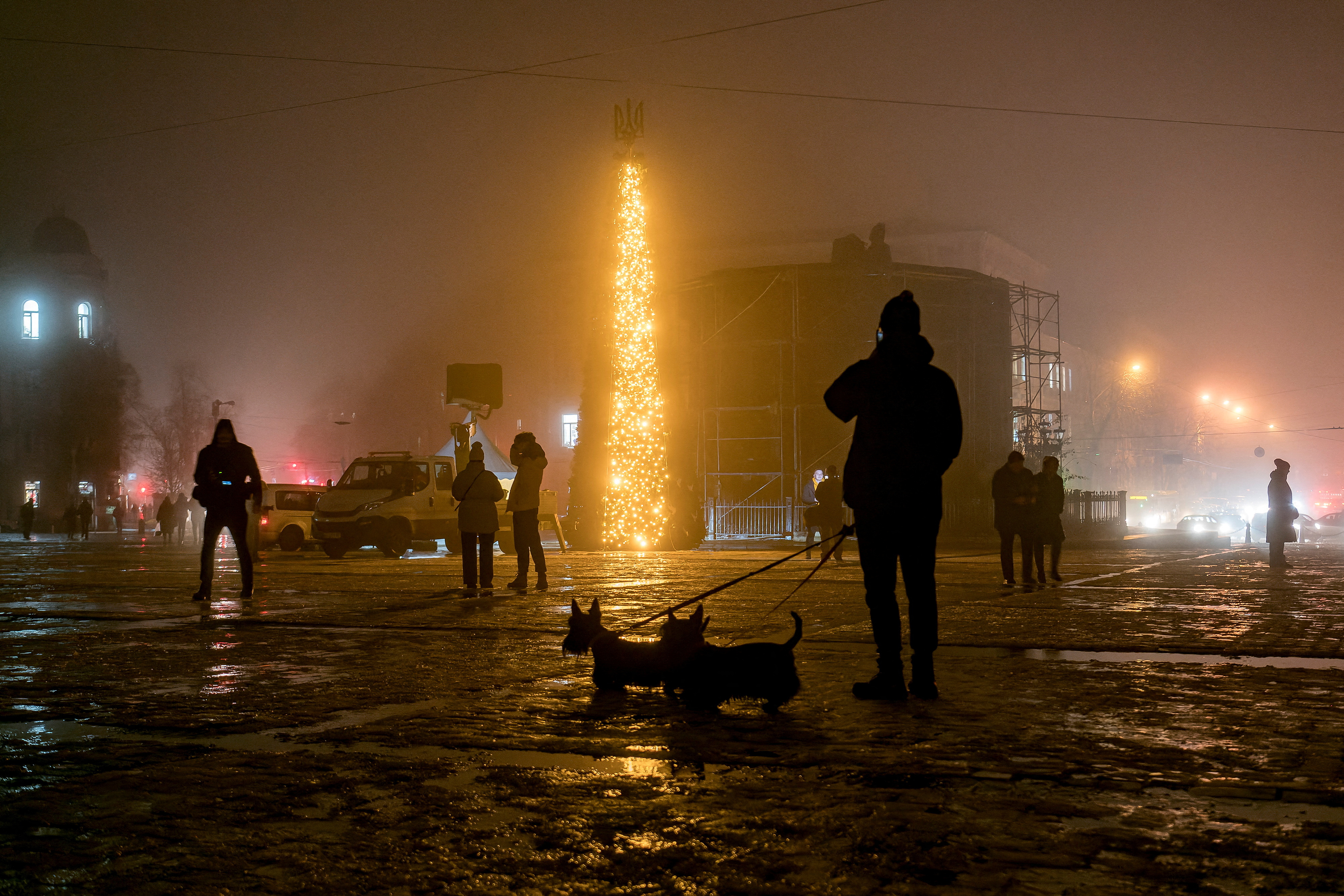 People walk past a Christmas tree during heavy fog at the Sofiyska square in Kyiv. Vladyslav Musiienko/Reuters