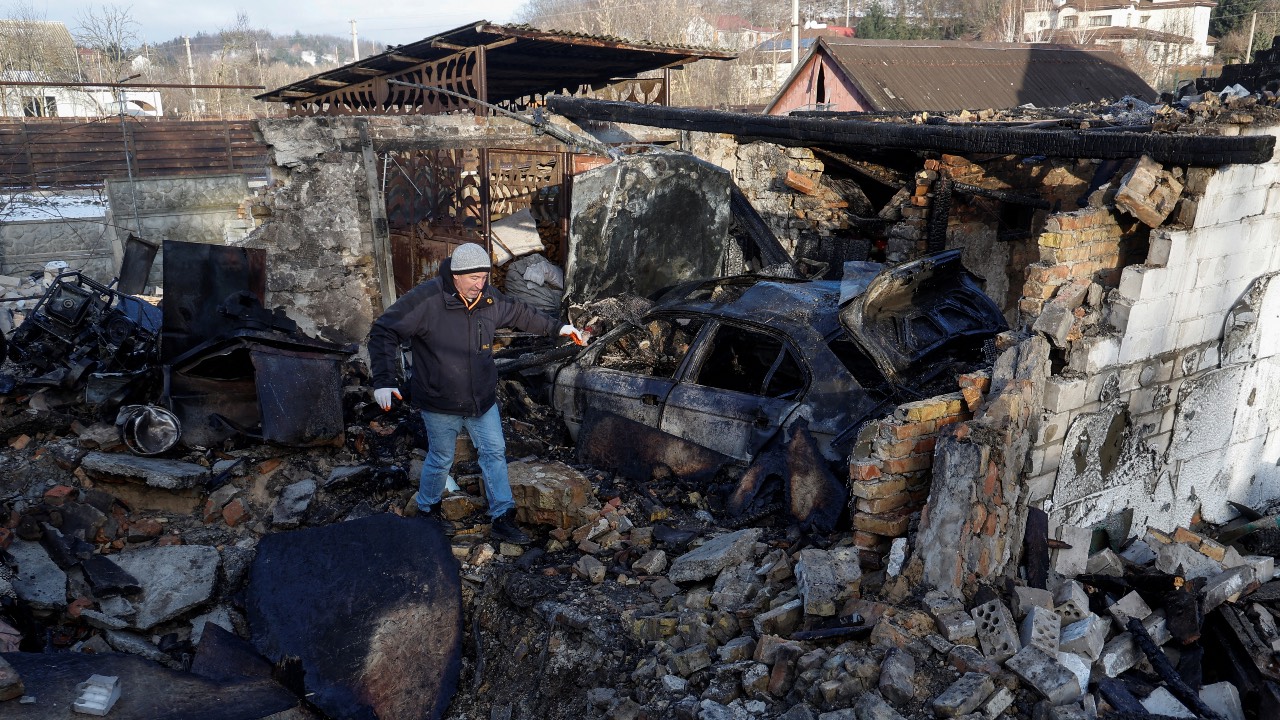 A local resident inspects the remains of his garage, destroyed during a Russian drone strike, in the village of Stari Bezradychi, in Kyiv region. /Valentyn Ogirenko/Reutere