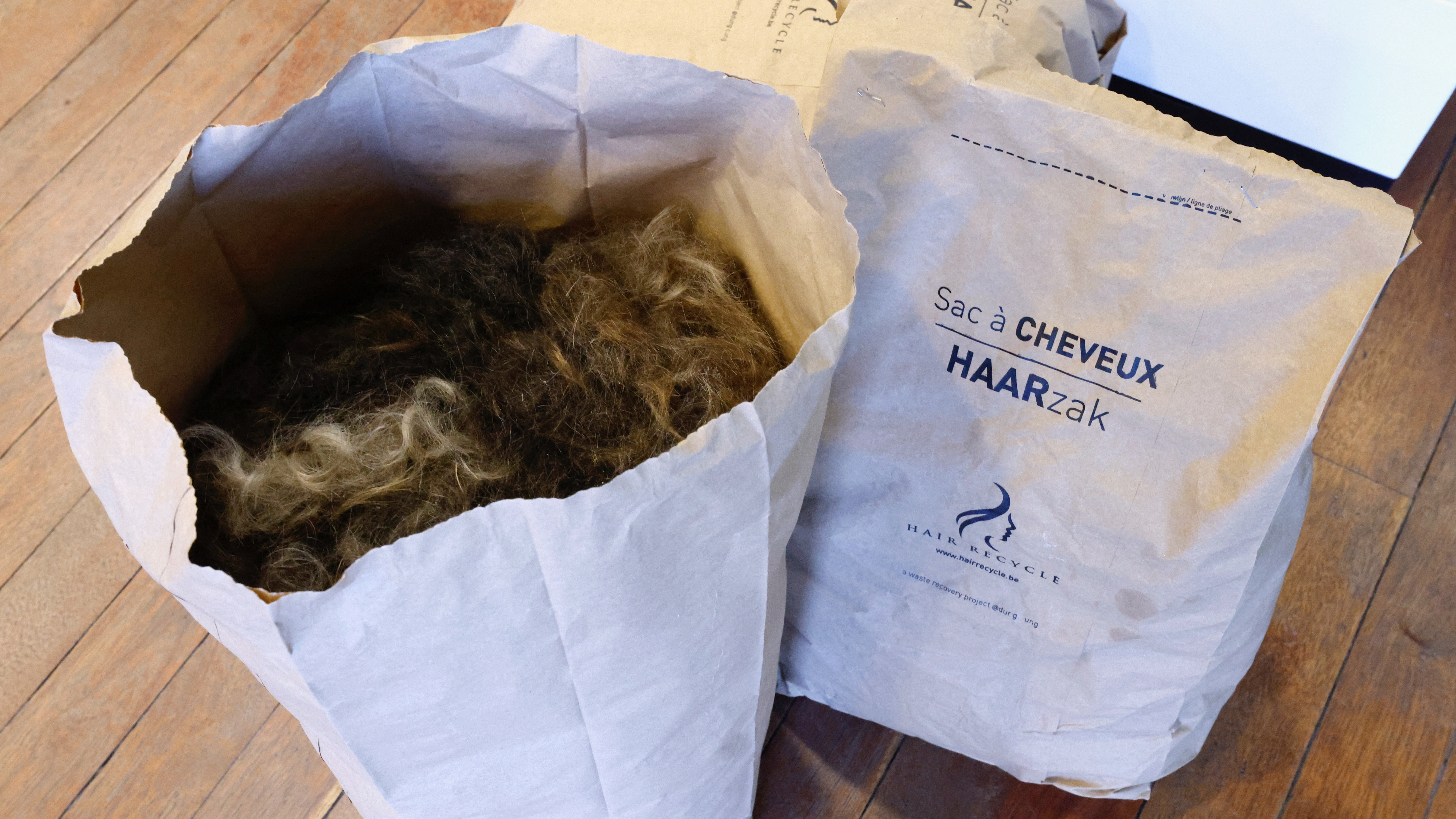 The Hair Recycle project puts the hair into a machine which turns them into matted squares. /ReutersYves Herman