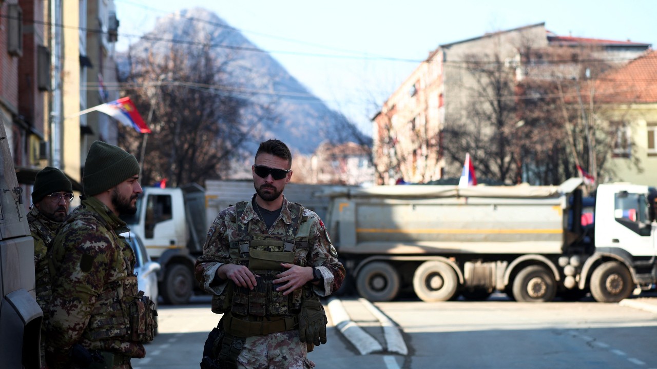 Members of the Italian Armed Forces, part of the NATO peacekeeping mission in Kosovo, stand near a roadblock in the northern part of the ethnically-divided town of Mitrovica. /Florion Goga/Reuters