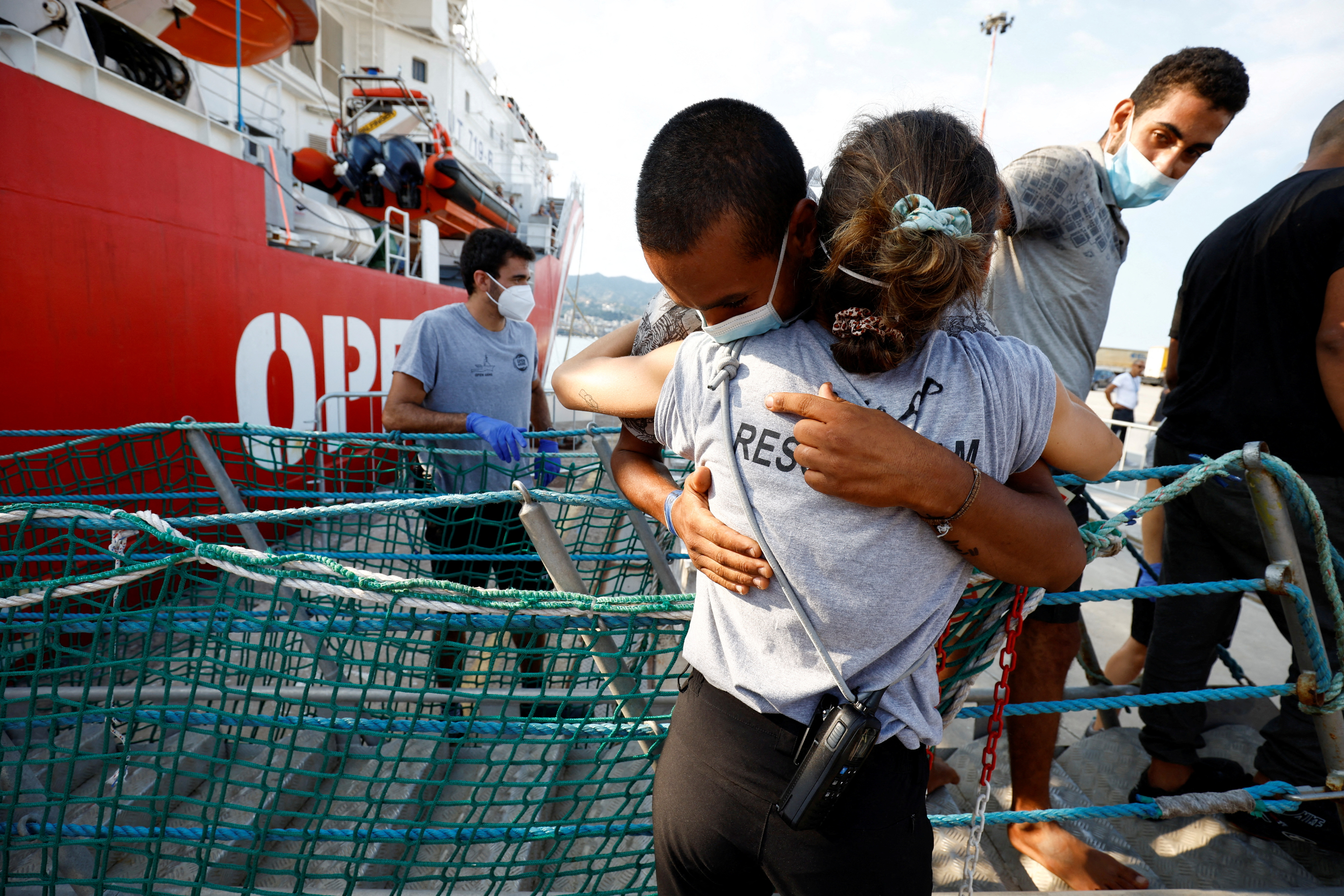 Migrants disembark from Open Arms rescue boat after arriving at Messina port, Sicily, Italy in August 2022. /Juan Medina/Reuters