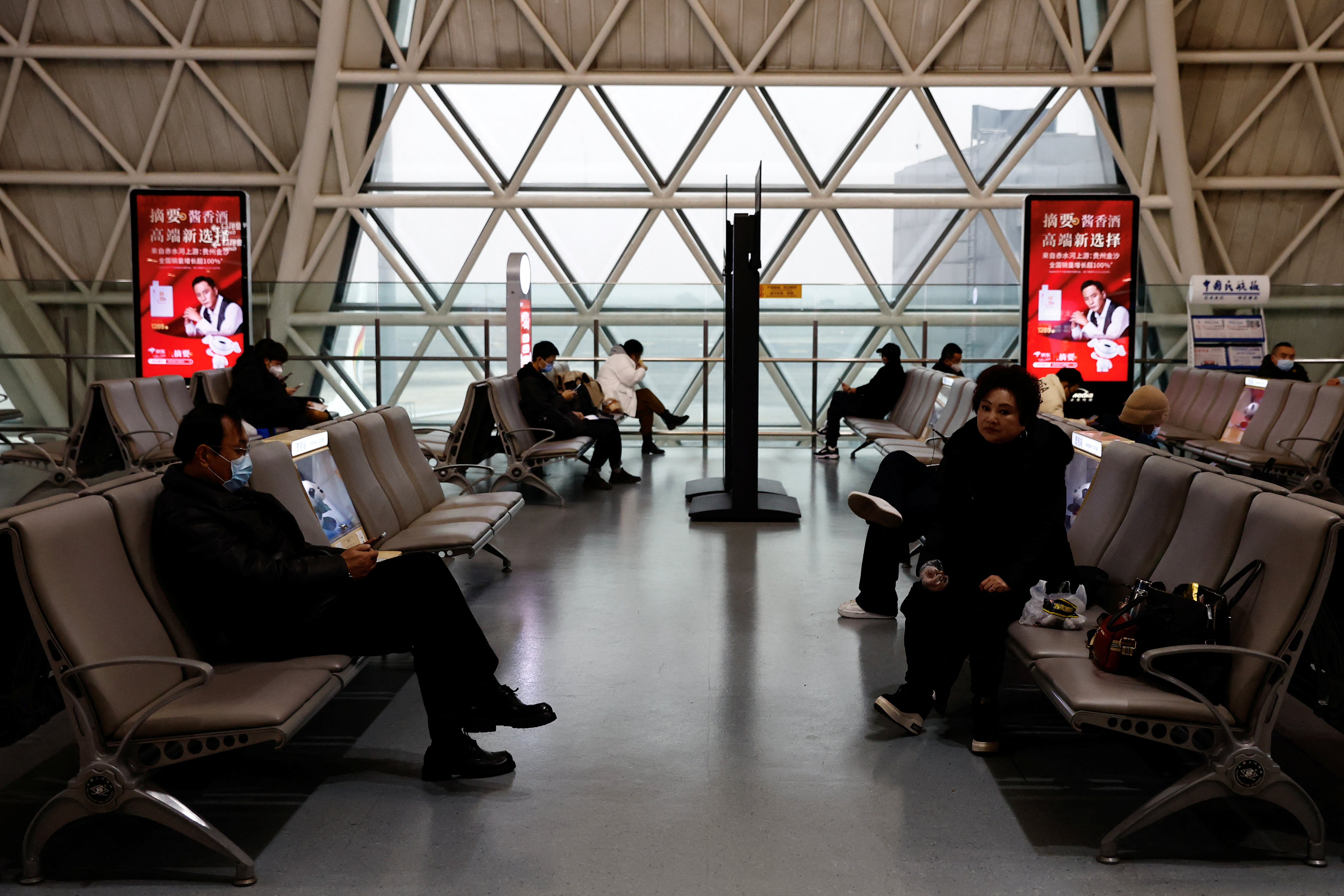 Travellers wait to board their plane at Chengdu Shuangliu International Airport, Sichuan province, China December 30, 2022. Reuters/Tingshu Wang