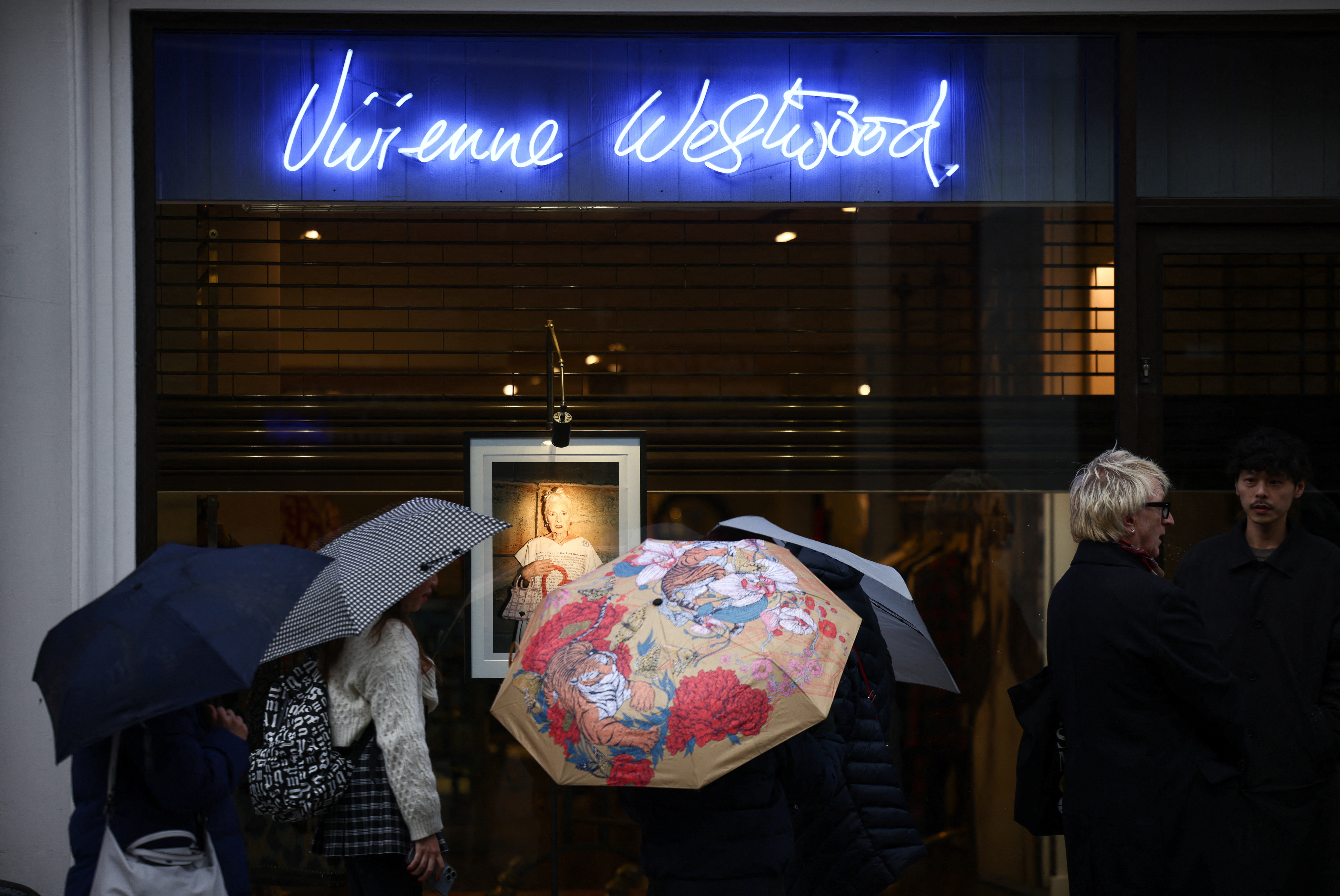 People view a eulogy and photograph displayed in the window of a Vivienne Westwood store in Mayfair, London on Friday. Reuters/Henry Nicholls