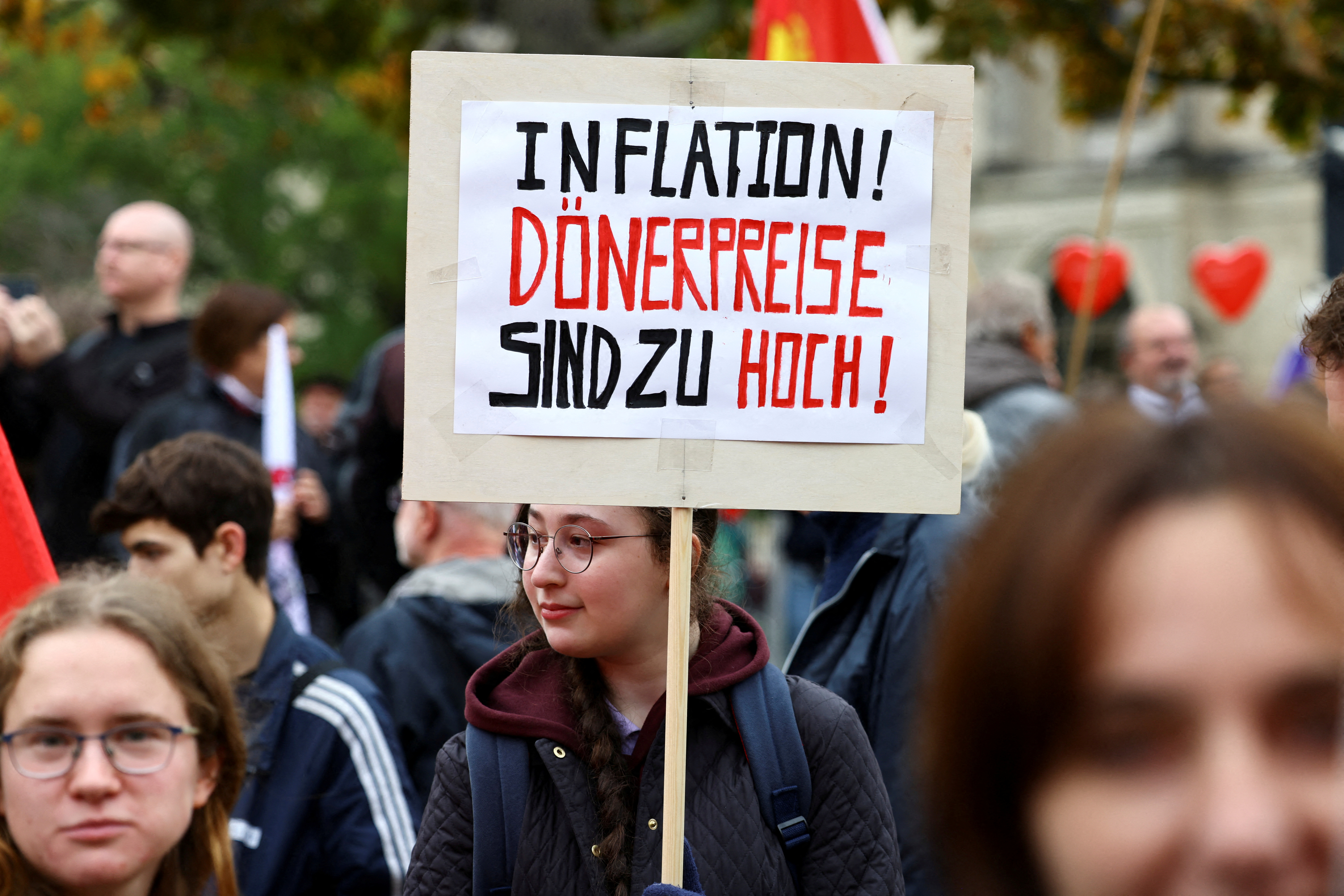 A demonstrator holds a sign which reads 'Inflation! Doner prices are too high!' during a protest to promote energy independence from Russia, in Berlin,in October. Reuters/Christian Mang/File Photo