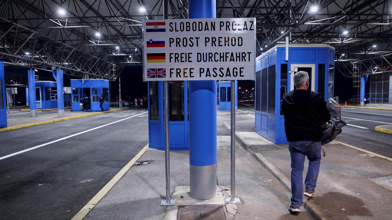 A person walks by during the opening of the border crossing as Croatia enters the EU's control-free Schengen Area, in Bregana, Croatia. /Borut Zivulovic/Reuters