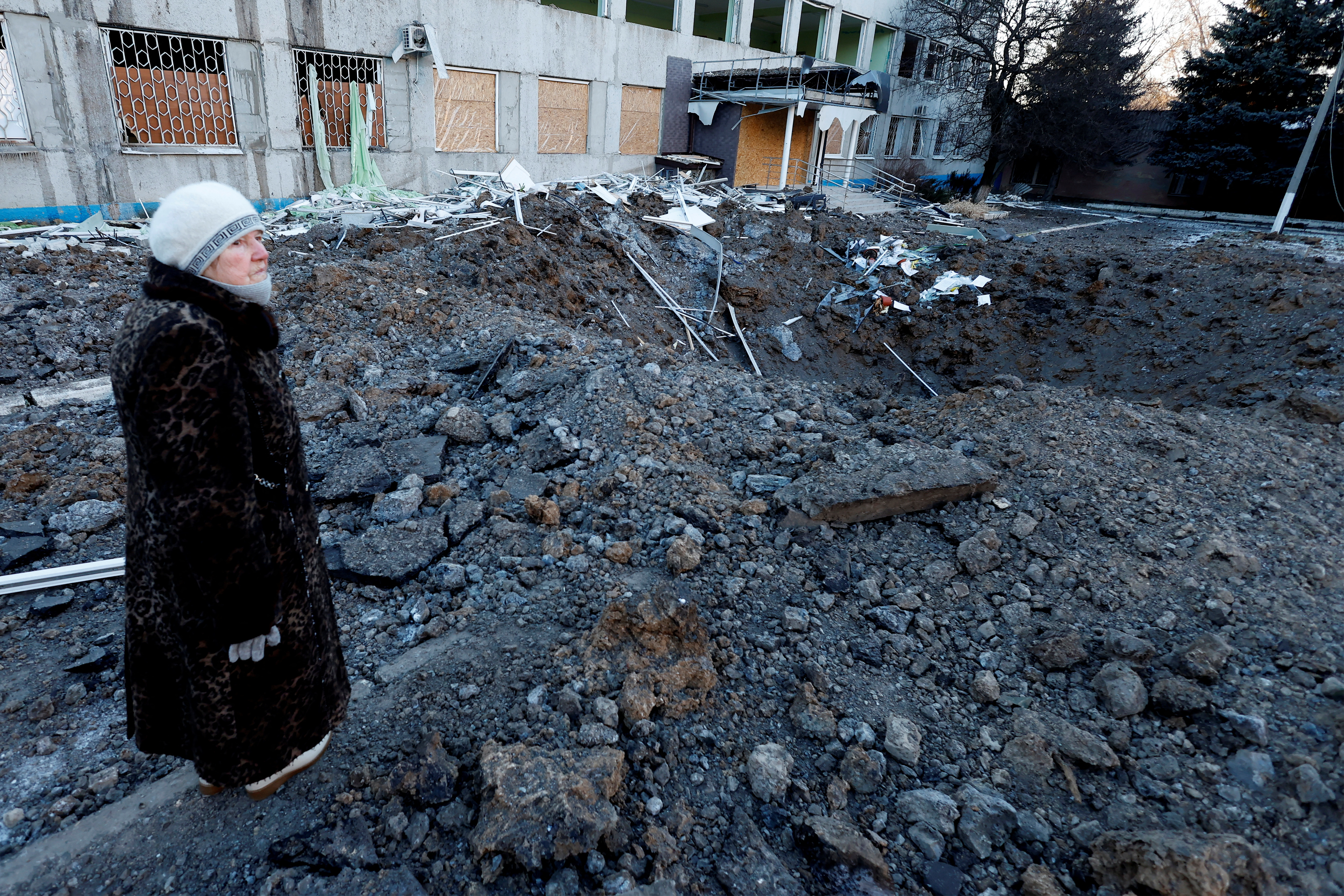 A woman looks at the site of a missile strike in Kramatorsk on January 8. /Clodagh Kilcoyne/Reuters