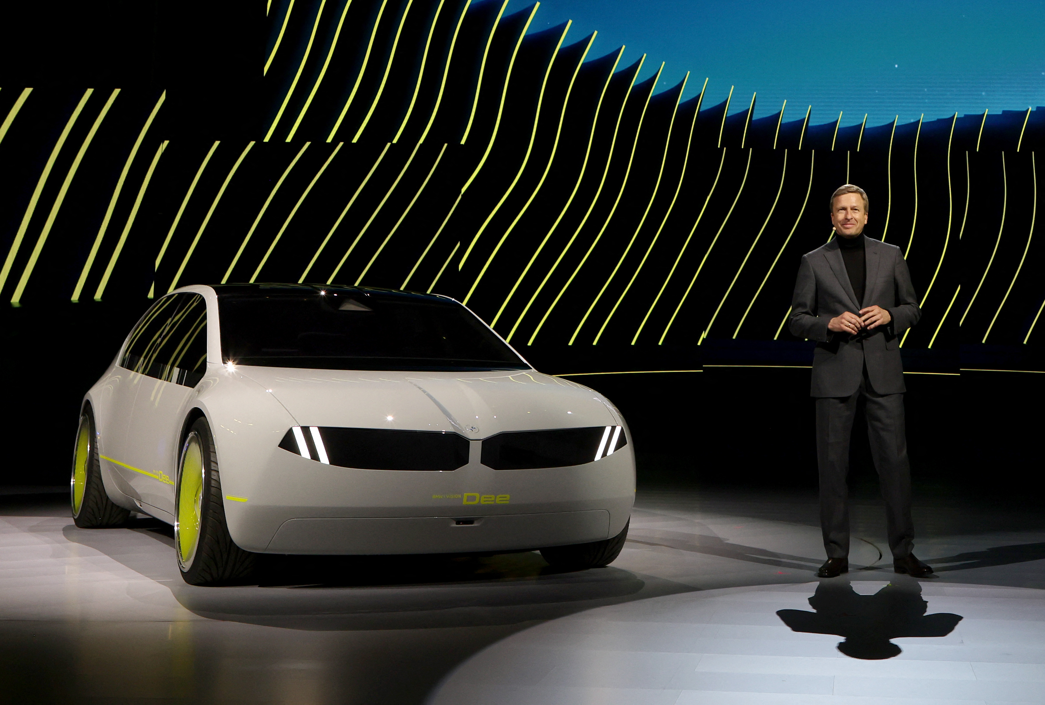 BMW's board chairman Oliver Zipse introduces the BMW i Vision Dee (Digital Emotional Experience) concept EV sport sedan during at CES 2023 in Las Vegas. /Ethan Miller/Getty Images/AFP