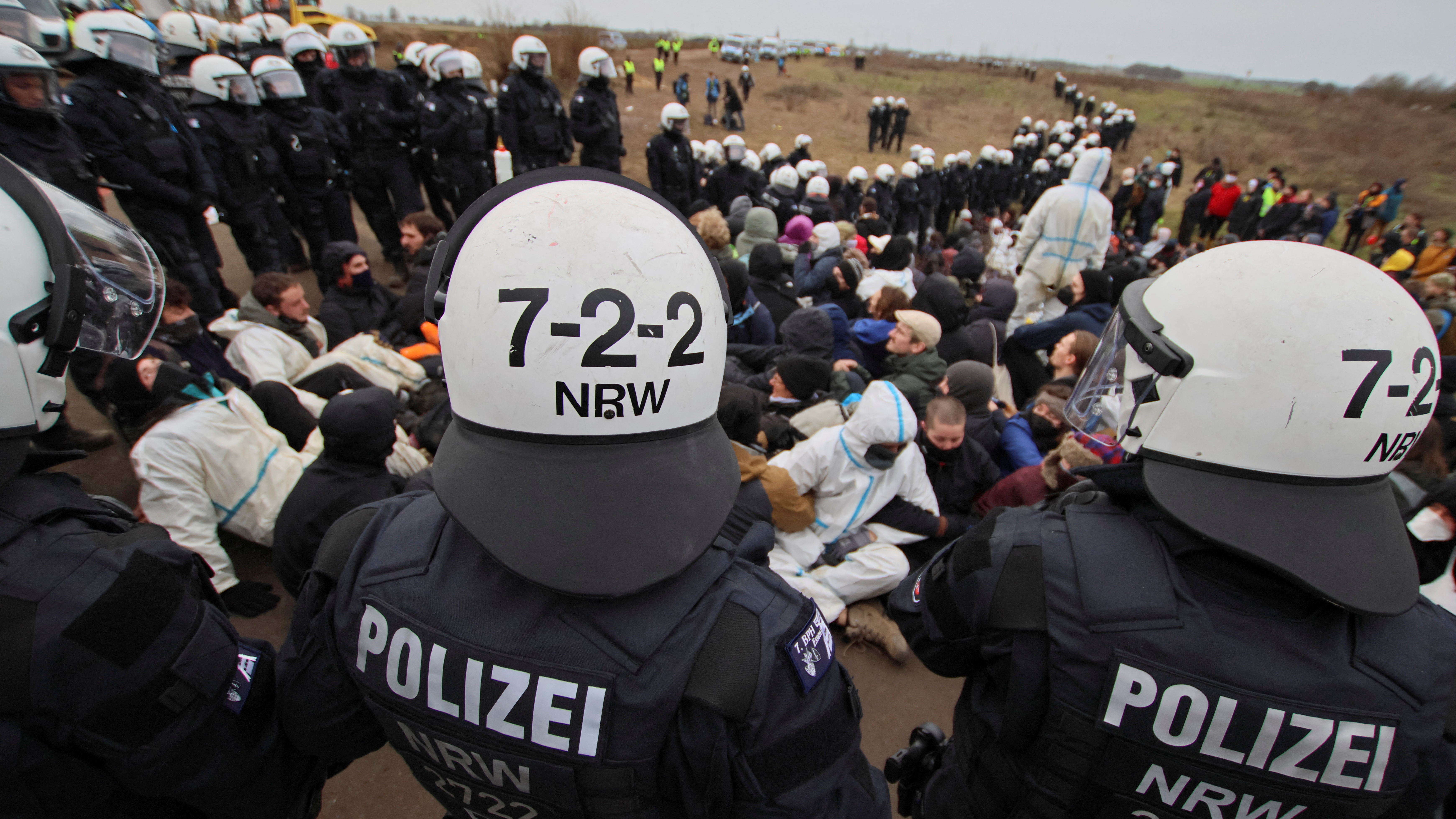 Police officers stand guard as activists demonstrate at Luetzerath. /Wolfgang Rattay/Reuters 
