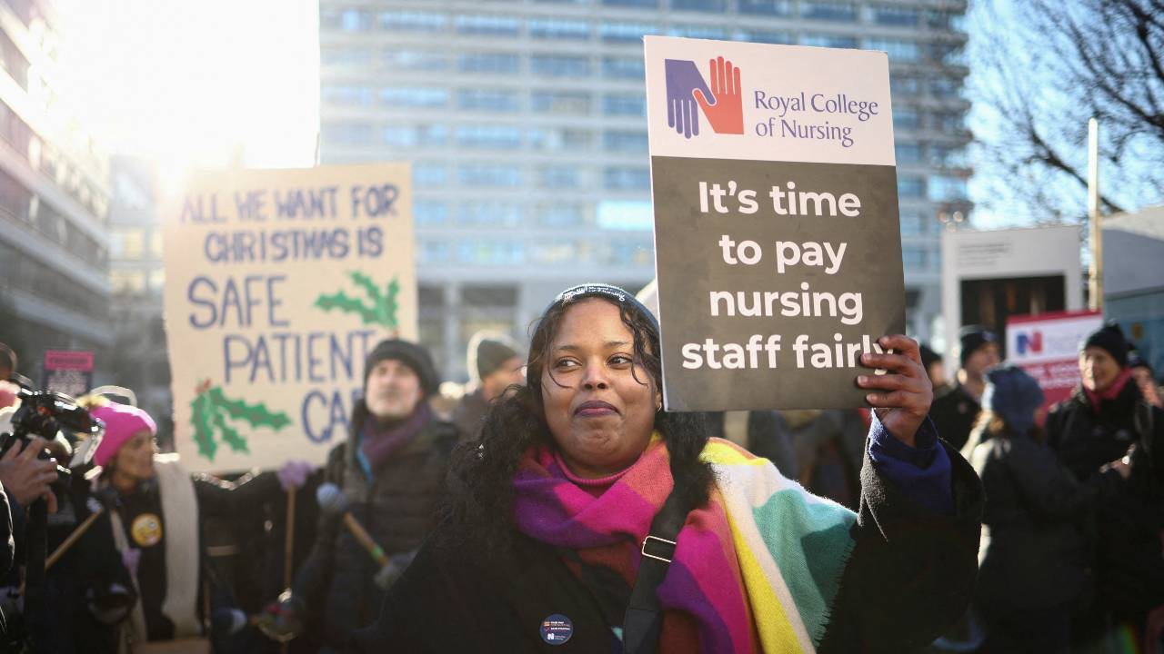 NHS nurses hold placards during a strike amid a dispute with the government over pay in London. /Henry Nicholls/Reuters