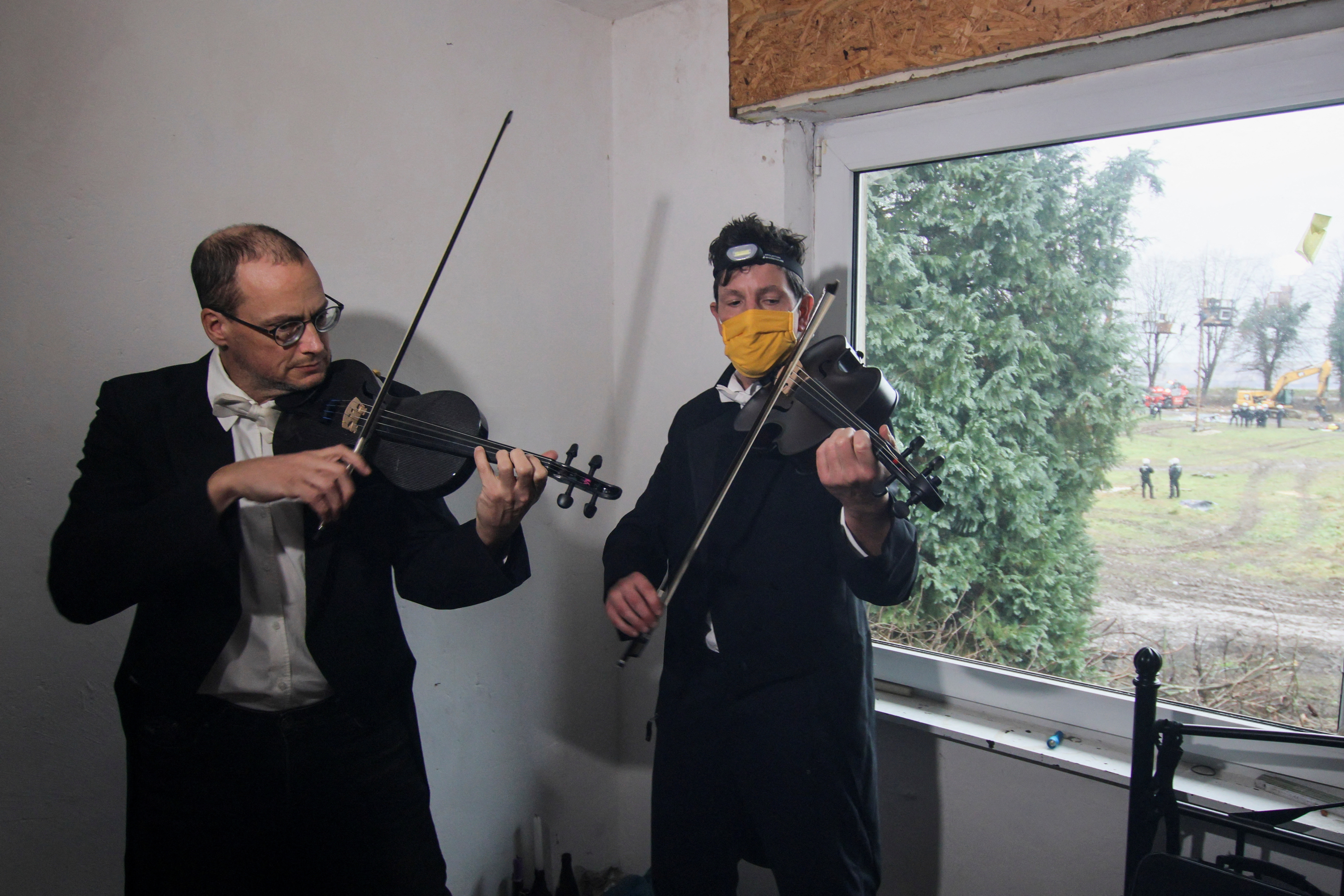 Musicians Thomas Gerlinger and Luppe play violin and viola in an abandoned house in protest against demolishing Luetzerath village to expand the Garzweiler open-cast lignite mine on Thursday. /Wolfgang Rattay/Reuters