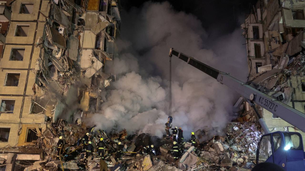 Rescuers work at the site where an apartment building was heavily damaged by a Russian missile strike in Dnipro. /Yevhen Titov/Reuters