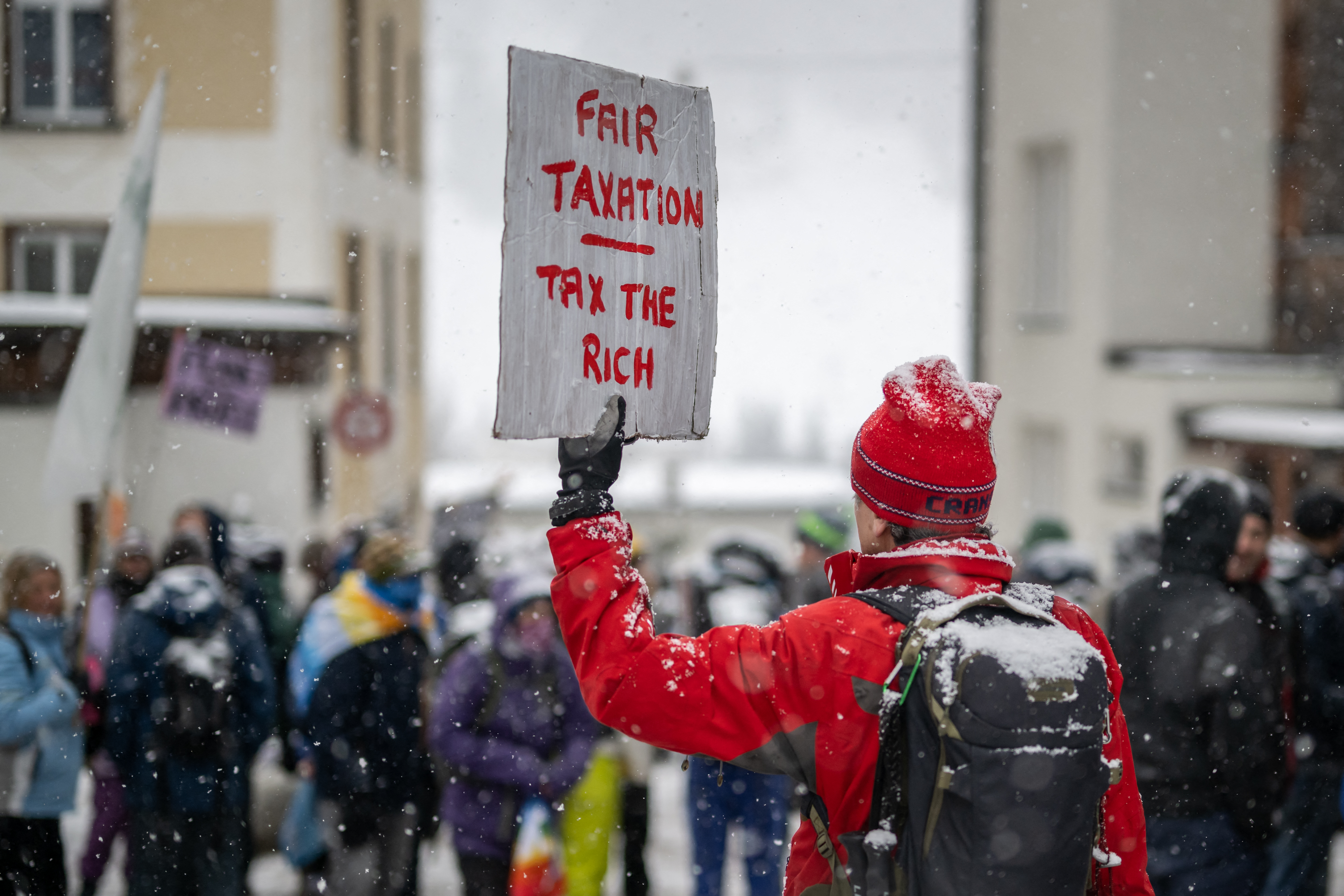 On the eve of Davos 2023, Young Socialists Switzerland activists call for a climate tax on the rich. /Fabrice Coffrini/AFP