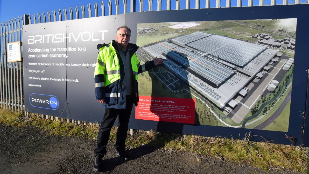 Peter Rolton, executive chairman of Britishvolt, shows a billboard at the site of the company's planned battery plant which has been mothballed. /Nick Carey/File/Reuters
