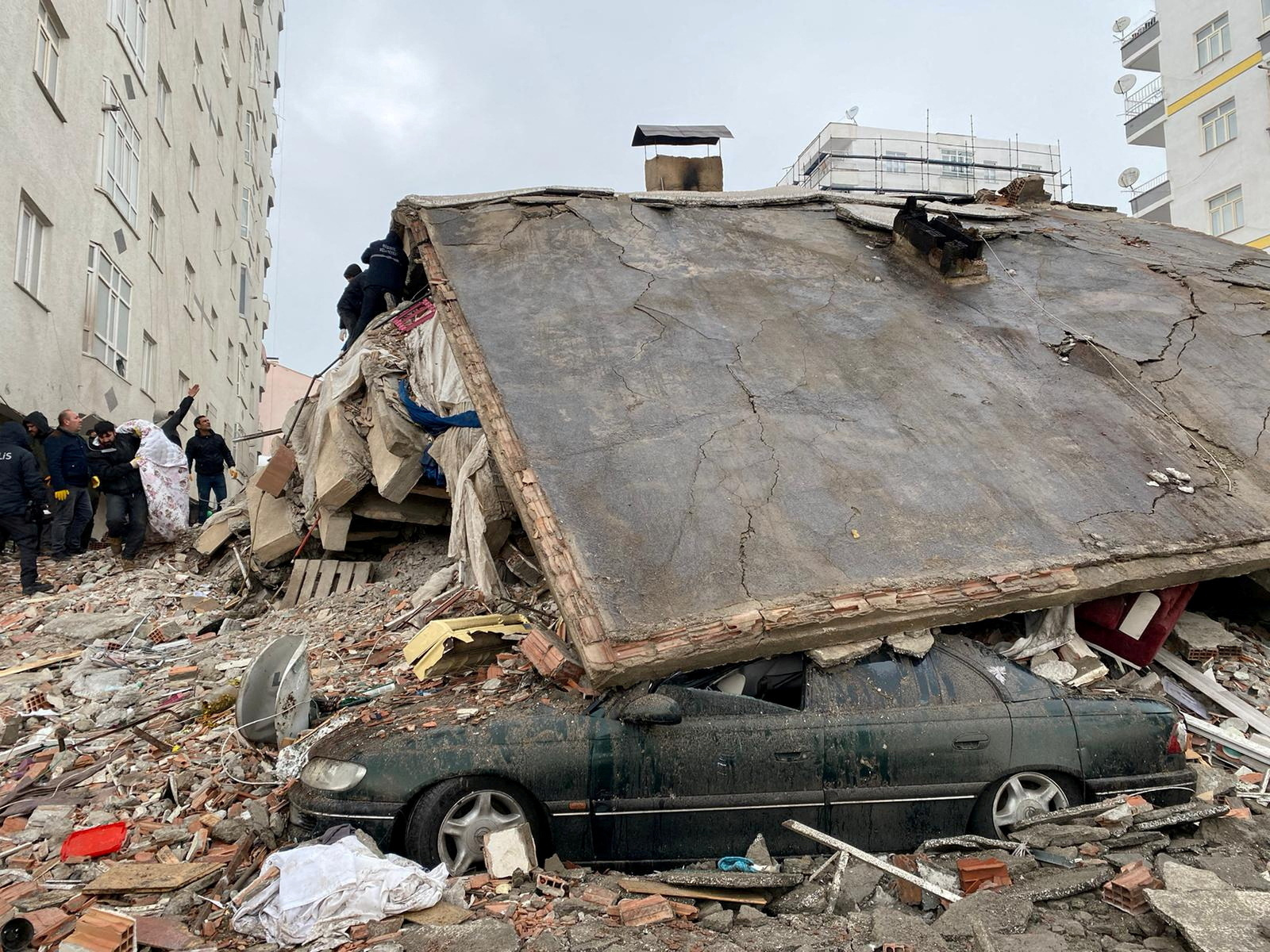 An apartment block was reduced to rubble in the city of Diyabakir, where rescuers are desperately searching for survivors./Sertac Kayar/Reuters.