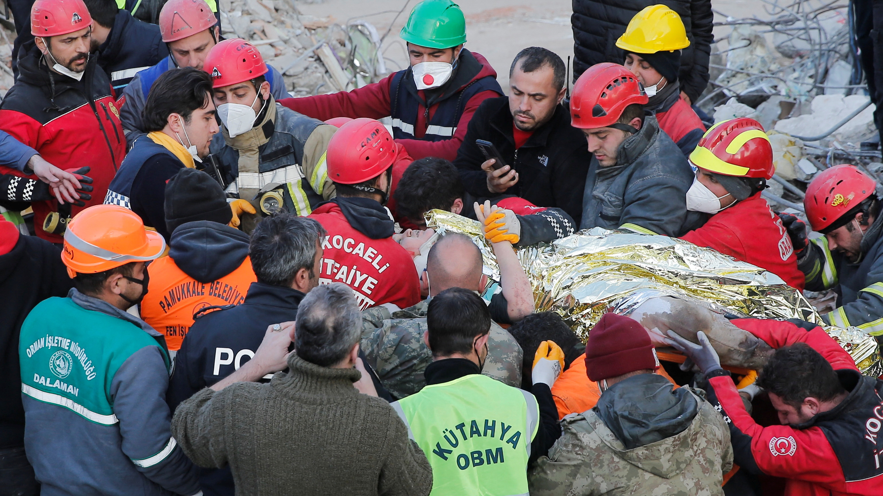 Rescuer workers carry Kaan, a-13-year old Turkish teenager, to an ambulance after being rescued from the rubble after 182 hours. /Dilara Senkaya/Reuters