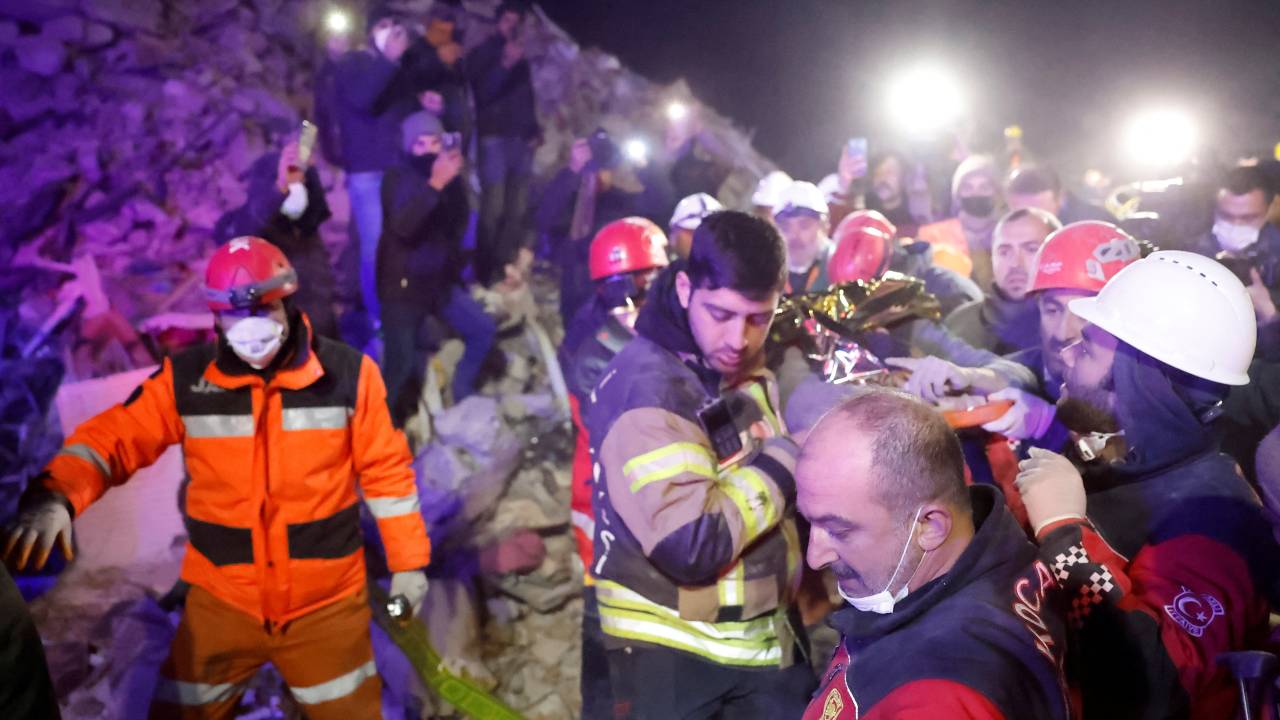 A person is pulled out from the rubble of a collapsed building, in the aftermath of a deadly earthquake in Turkey's Hatay. /Clodagh Kilcoyne/Reuters