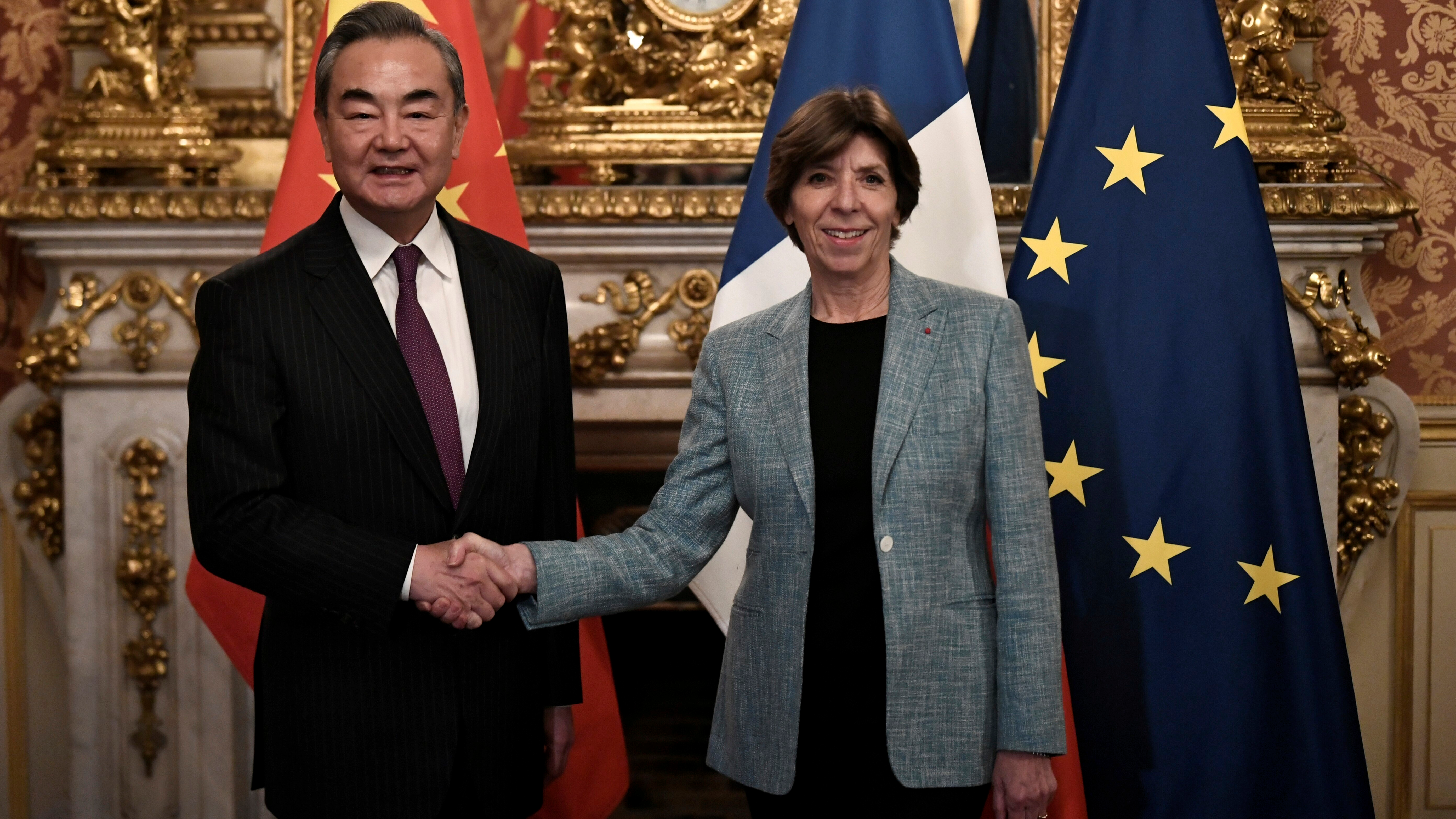 China's top diplomat, Wang Yi, greets French Foreign Minister Catherine Colonna in Paris