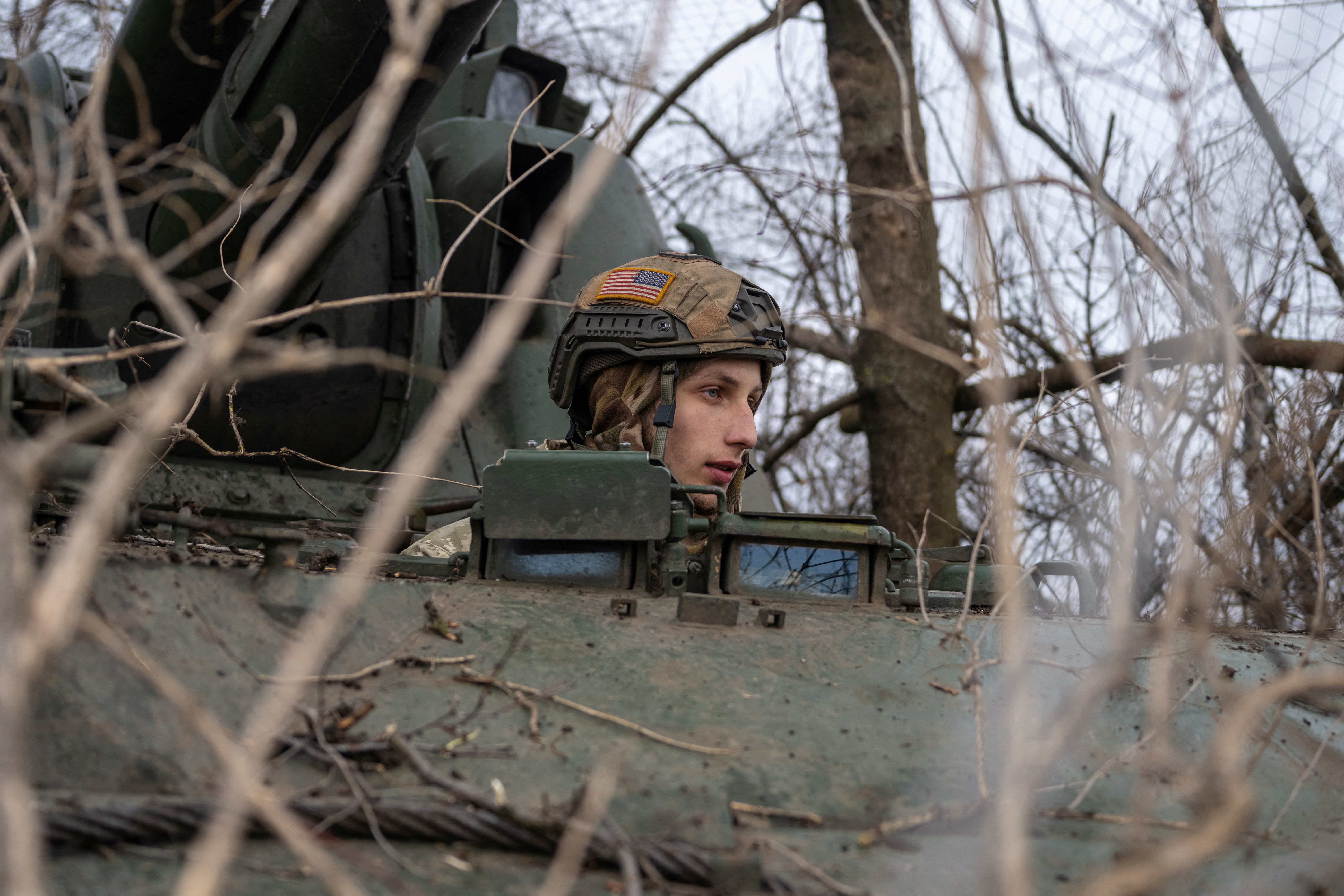 A Ukrainian soldier sits inside a 2S3 Akatsiya self-propelled howitzer, near the frontline town of Bakhmut. /Marko Djurica /Reuters