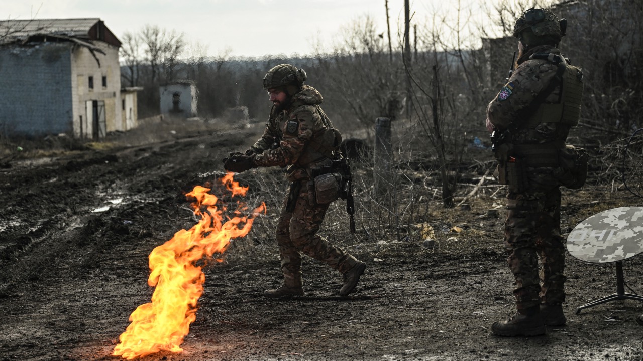 Ukrainian soldiers light a fire with gun powder to get warm near the city of Bakhmut in the region of Donbas. /Aris Messinis/AFP
