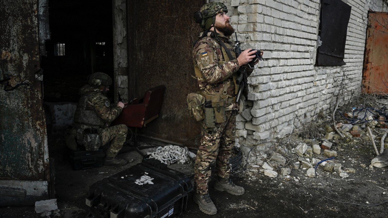 A Ukrainian soldier flies a drone to spot Russian positions near the city of Bakhmut. /Aris Messinis/AFP