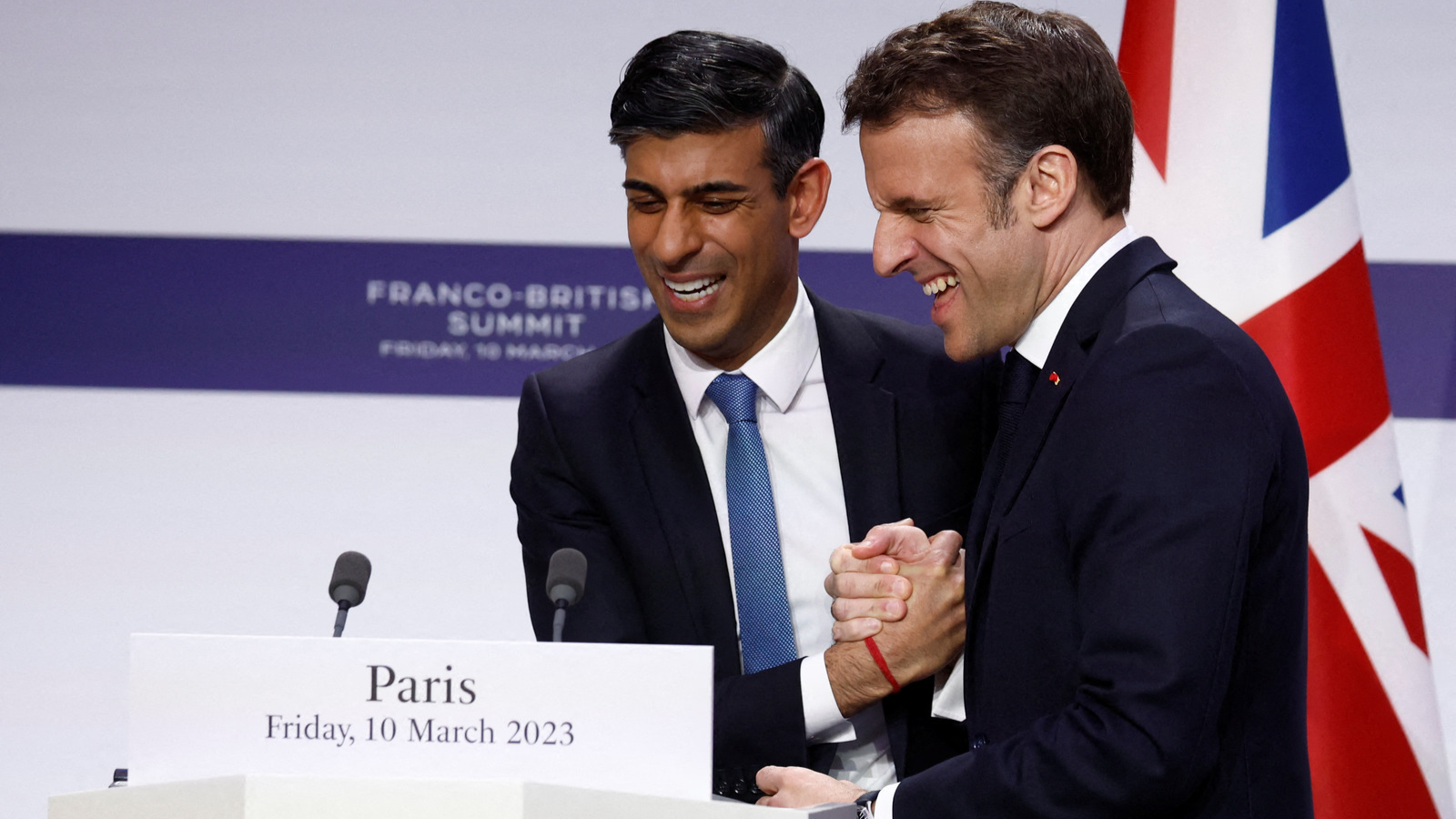 UK Prime Minister Rishi Sunak and French President Emmanuel Macron shook hands on a new $577m three-year agreement on Friday, under which the UK will fund France's efforts to stop migrants crossing the Channel on boats. /Gonzalo Fuentes/AFP
