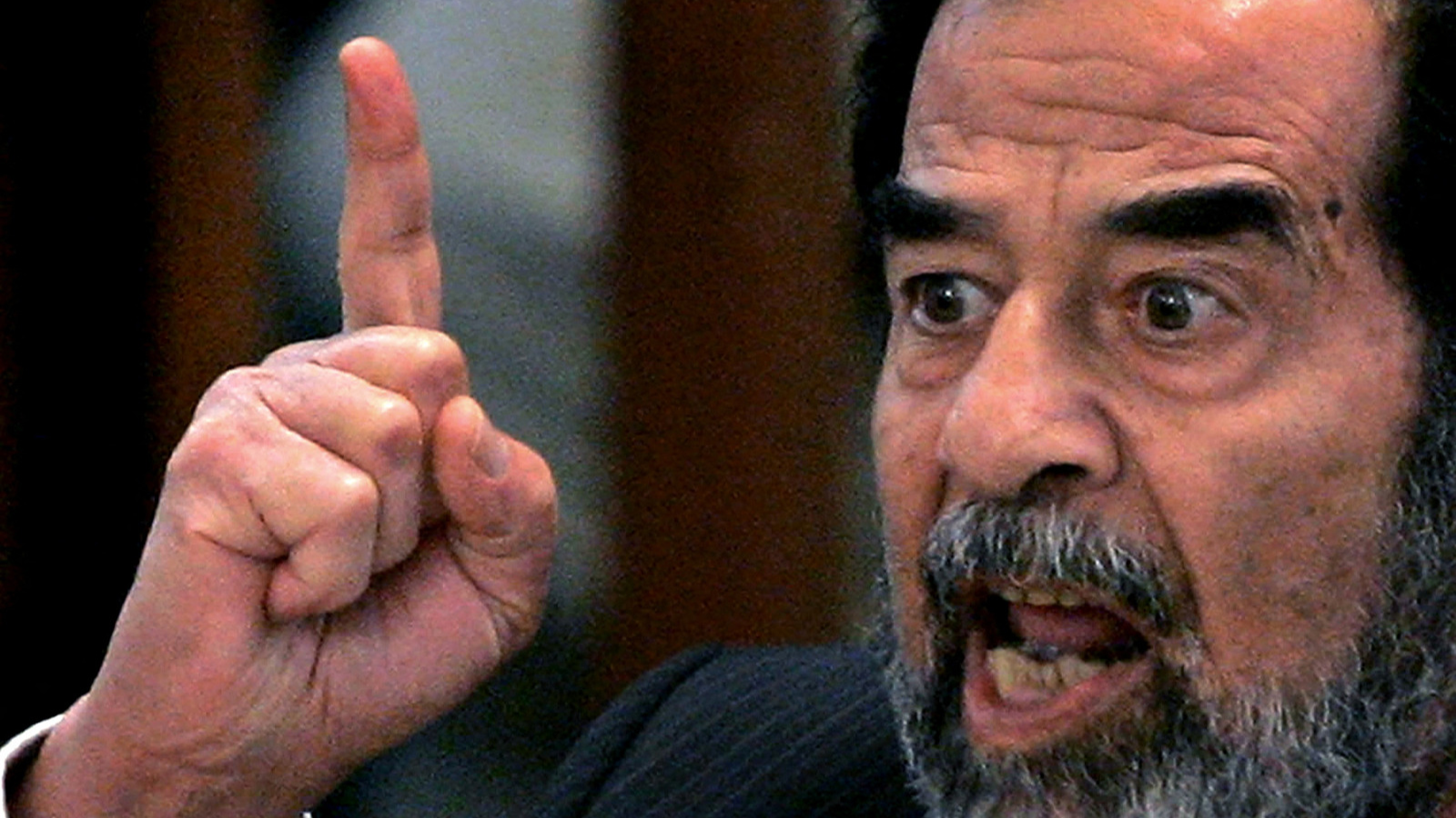 Former Iraqi leader Saddam Hussein addresses the court during his trial for genocide against Kurds. He was eventually sentenced to death by hanging. /Daniel Berehulak/Reuters