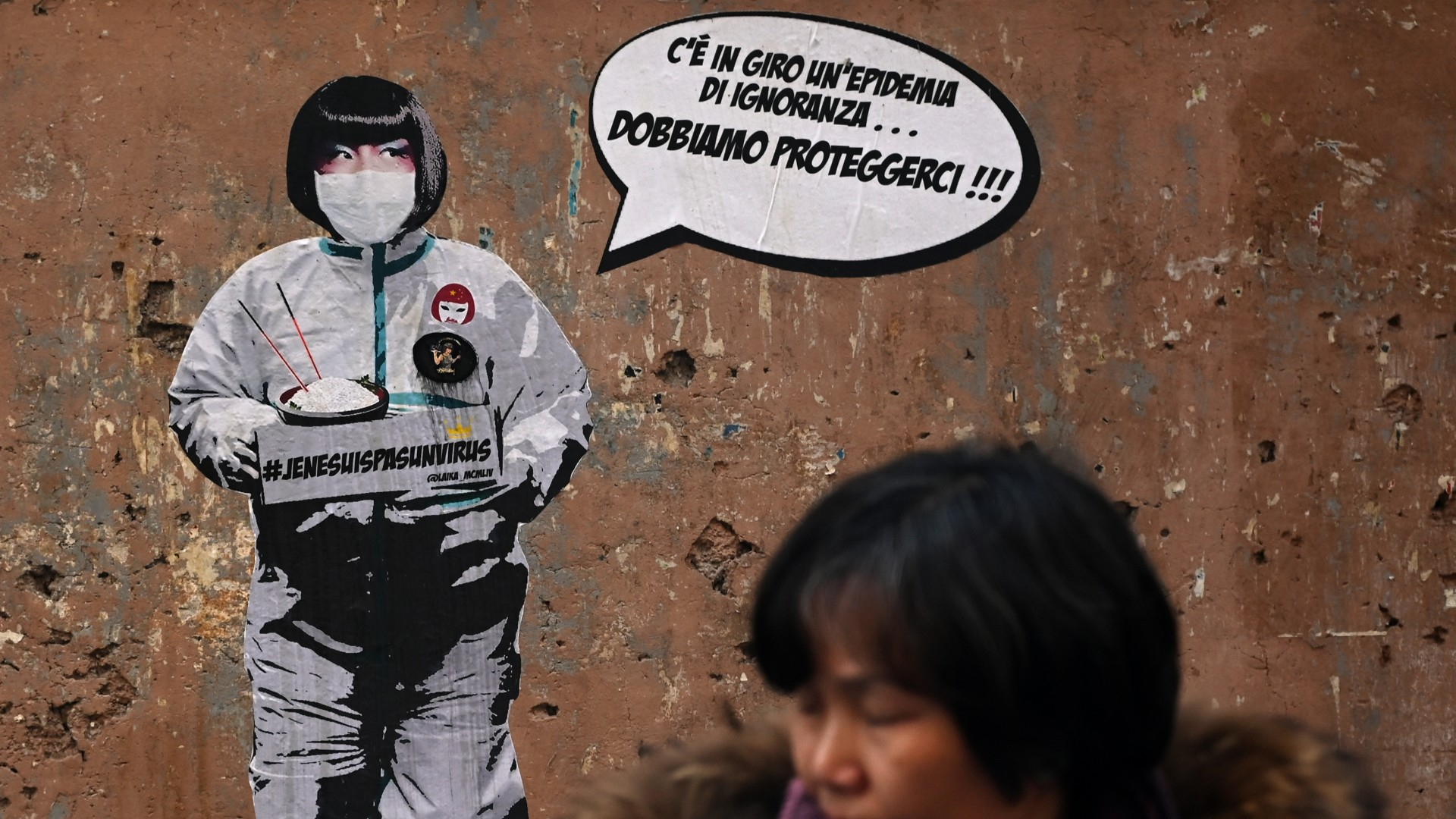 'An epidemic of ignorance is around – we must protect ourselves' says a mural by street artist Laika near Rome's Chinatown. /Filippo Monteforte/AFP