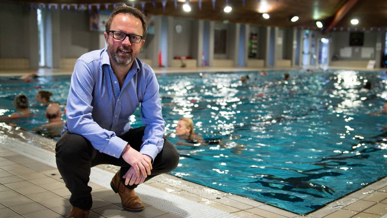 Deep Green chief executive Mark Bjornsgaard beside the pool heated by his data center. /Deep Green