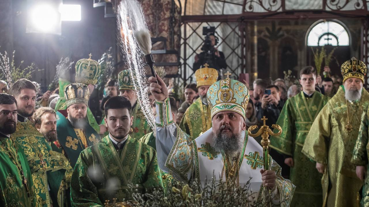 The head of the Orthodox Church of Ukraine sprays holy water on believers during a Palm Sunday ceremony in Kyiv. /Vladyslav Musiienko/Reuters