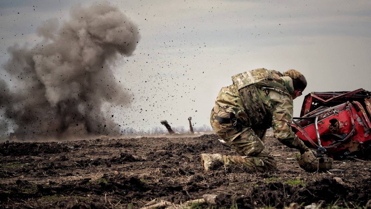 A Ukrainian serviceman ducks after throwing a grenade during training in Ukraine's Donbas region. /Yan Dorbronosov/Reuters