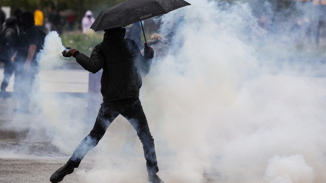 A protester clashes with police on the 12th day of action after the government pushed a pensions reform through parliament without a vote. /Thibaud Moritz/AFP