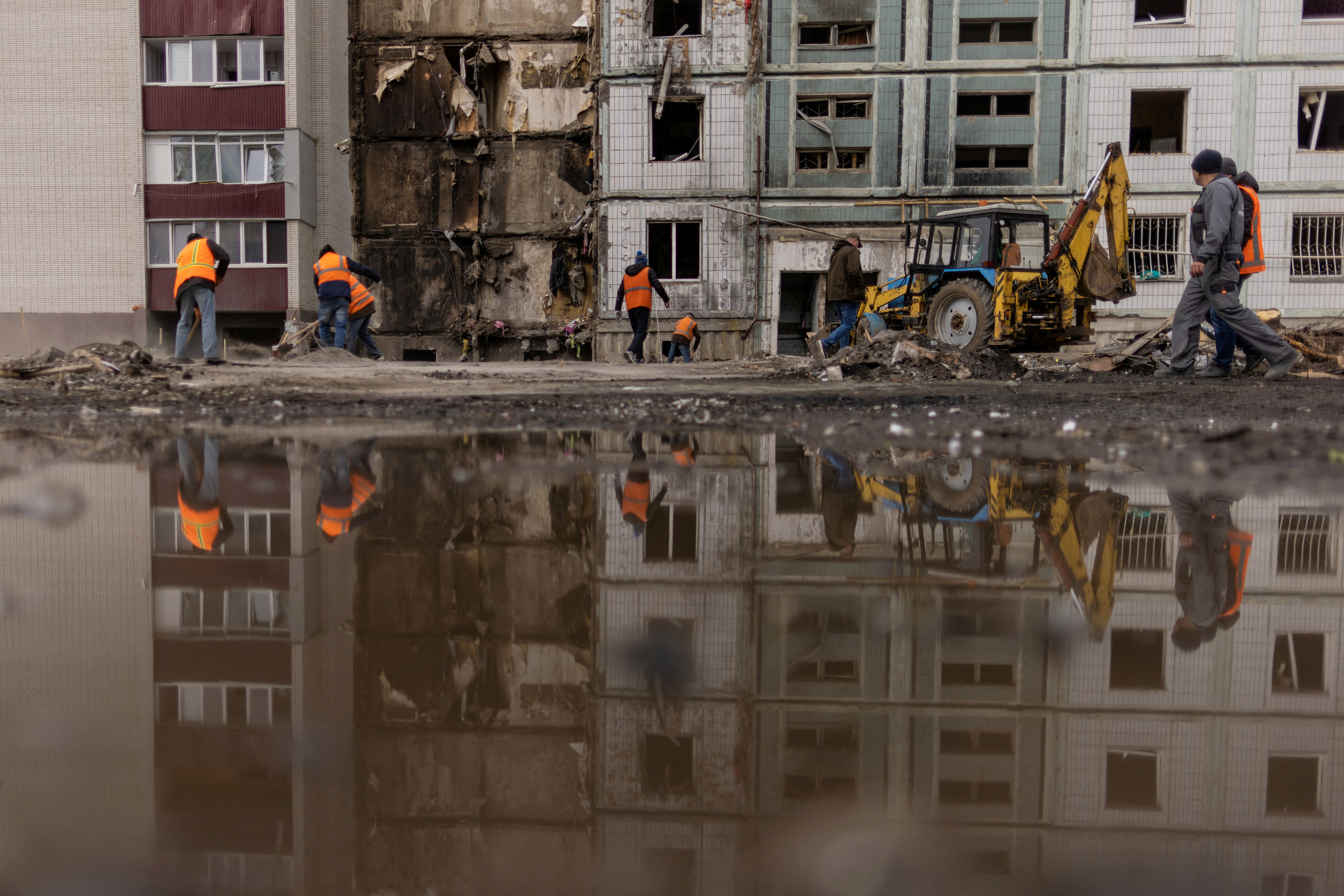 Workers clean up damaged apartments a deadly Russian missile strike in Uman. /Carlos Barria/Reuters