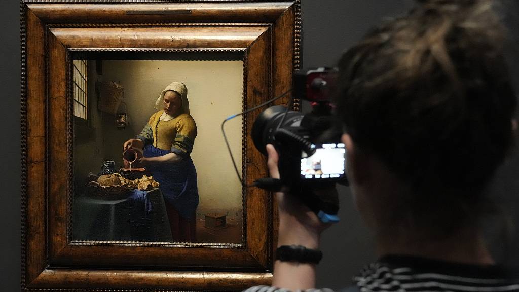 Vermeer's The Milkmaid being filmed at Amsterdam's Rijksmuseum. Could films showing artwork rival the experience of visiting exhibitions in person? /Peter Dejong/CFP