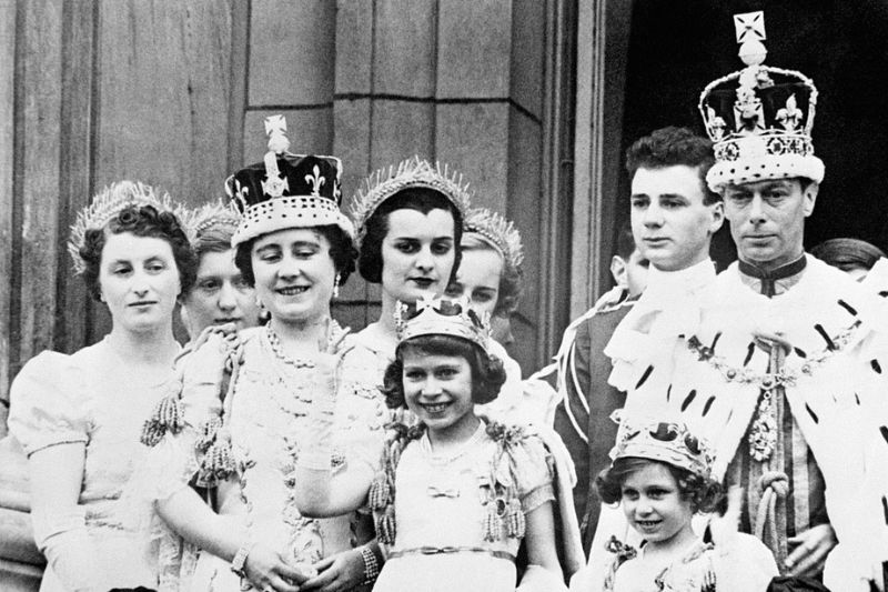 George VI, in the Imperial State Crown at right, and Queen Elizabeth after the 1937 coronation. Between them, waving, is the future Queen Elizabeth II. /Popperfoto via Getty Images/CFP