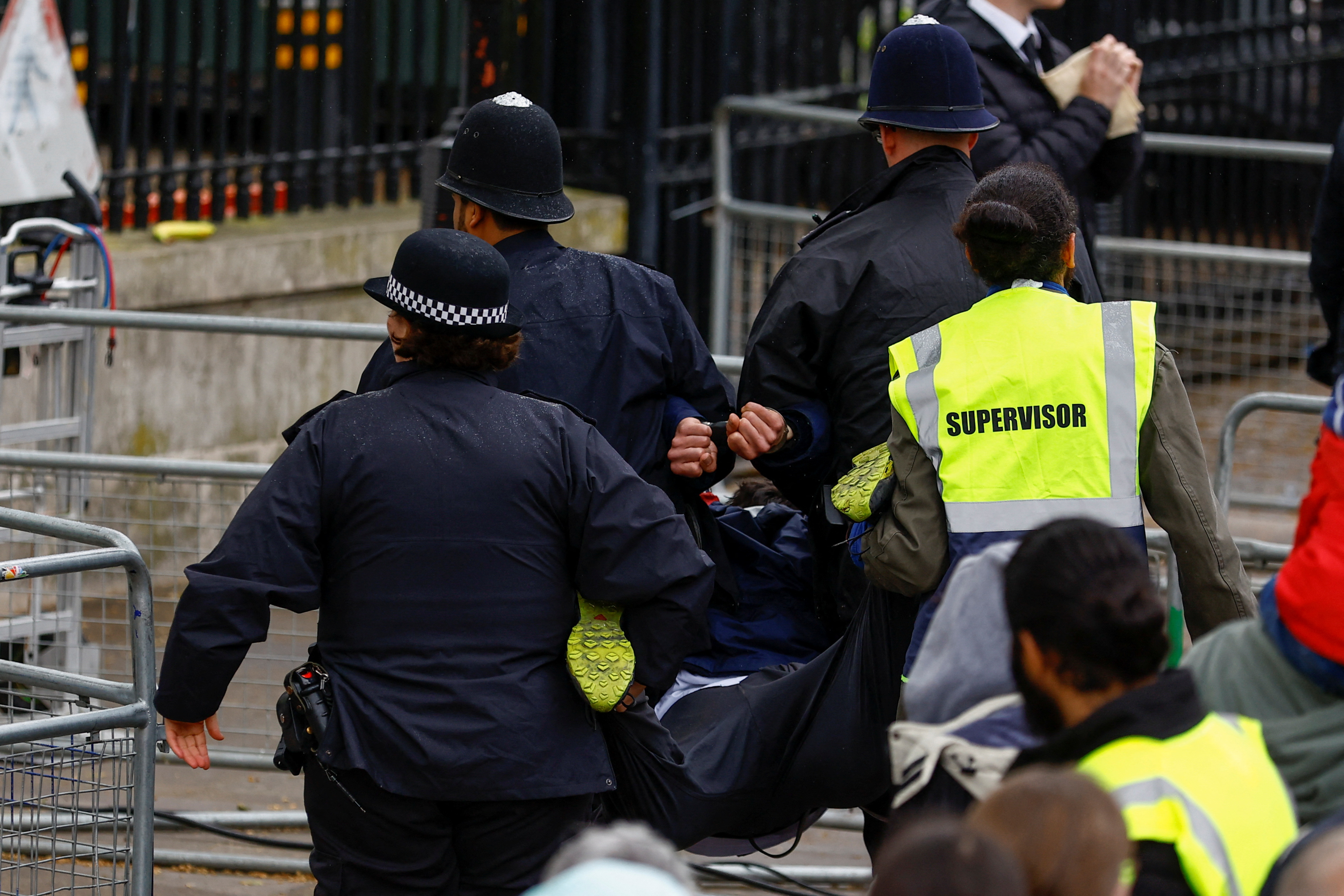 Police detain a protester on the day of the coronation in London. /Andrew Boyers/Reuters