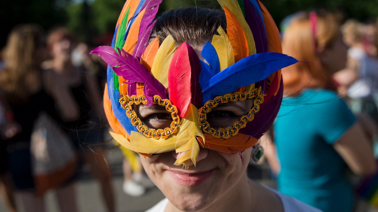A Gay Pride March participant wearing a mask in rainbow colors in Bucharest. /Daniel Mihailescu/AFP/File
