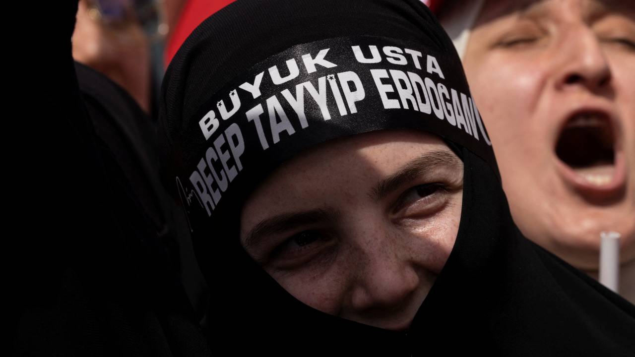An Erdogan supporter wearing a head band that reads 
