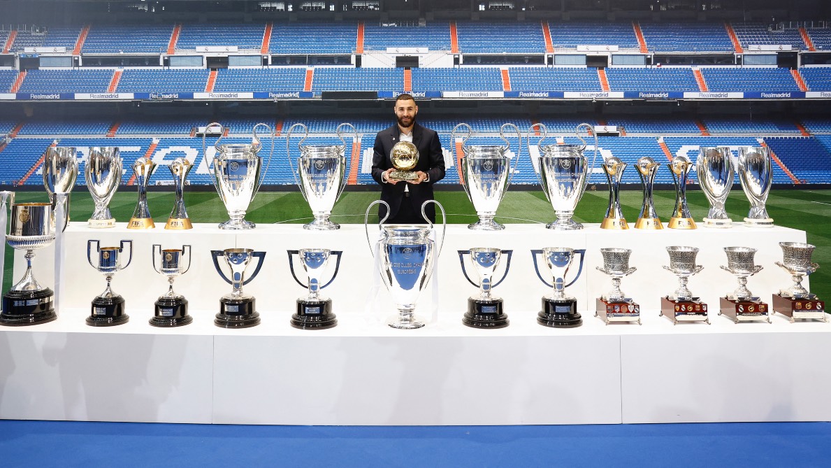 We're gonna need a bigger trophy cabinet: Benzema with the cups he helped Real Madrid to win. /HO/Realmadrid.com/AFP