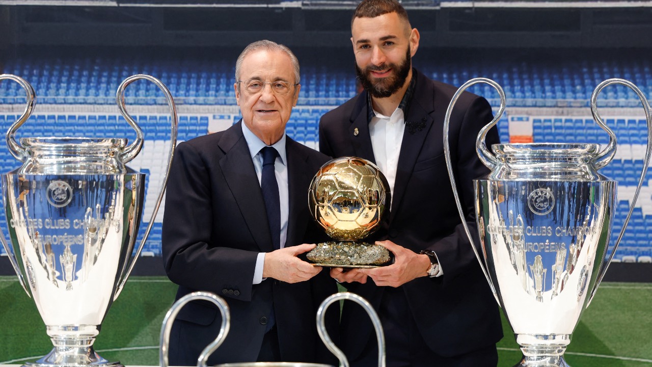 Benzema with Real Madrid's president Florentino Perez, his individual Ballon d'Or award, and a couple of Champions League trophies he won earlier. /HO/Realmadrid.com/AFP