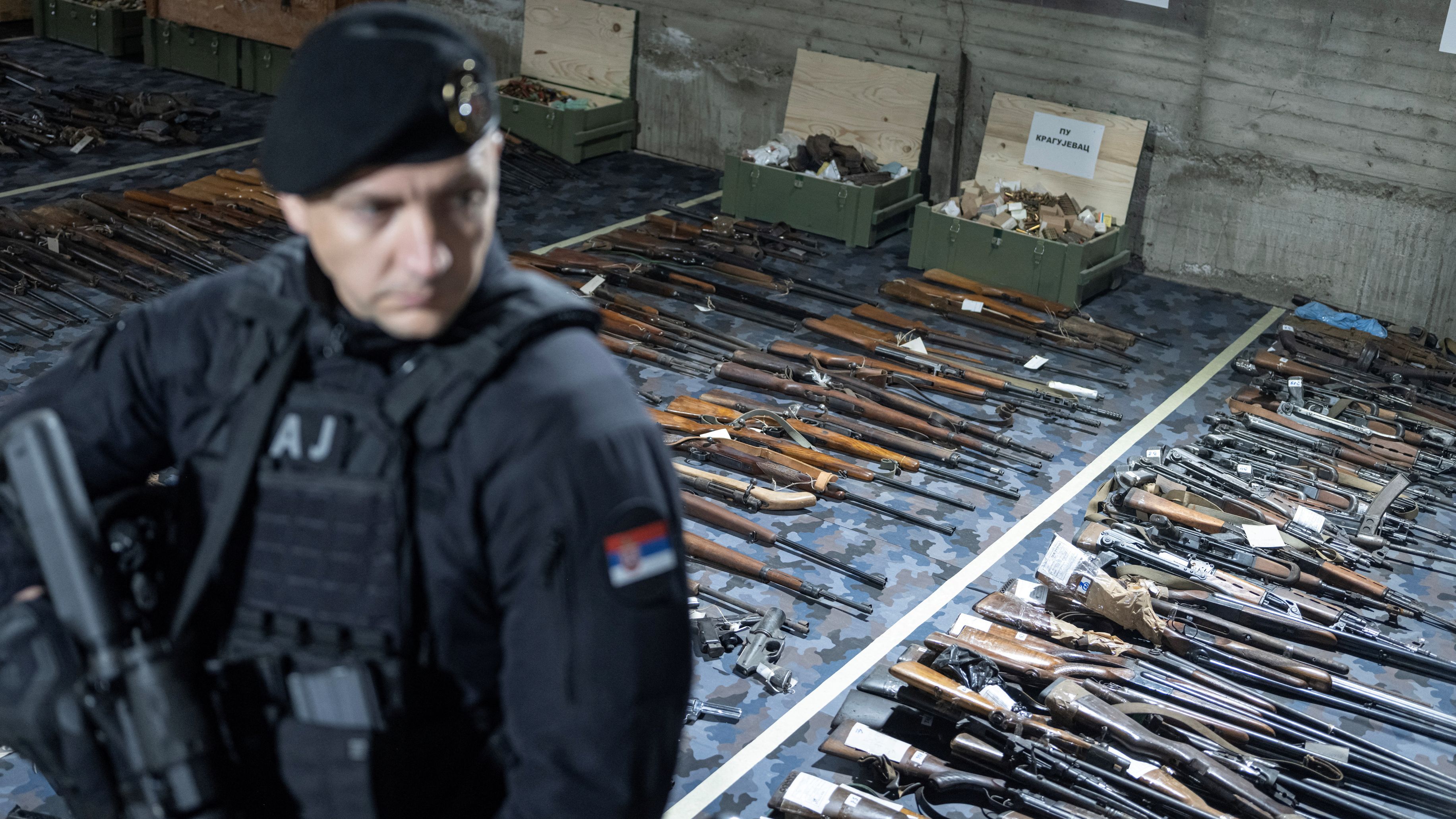 Police guard the weapons handed over at the start of the gun amnesty in Serbia./ Marko Djurica/Reuters